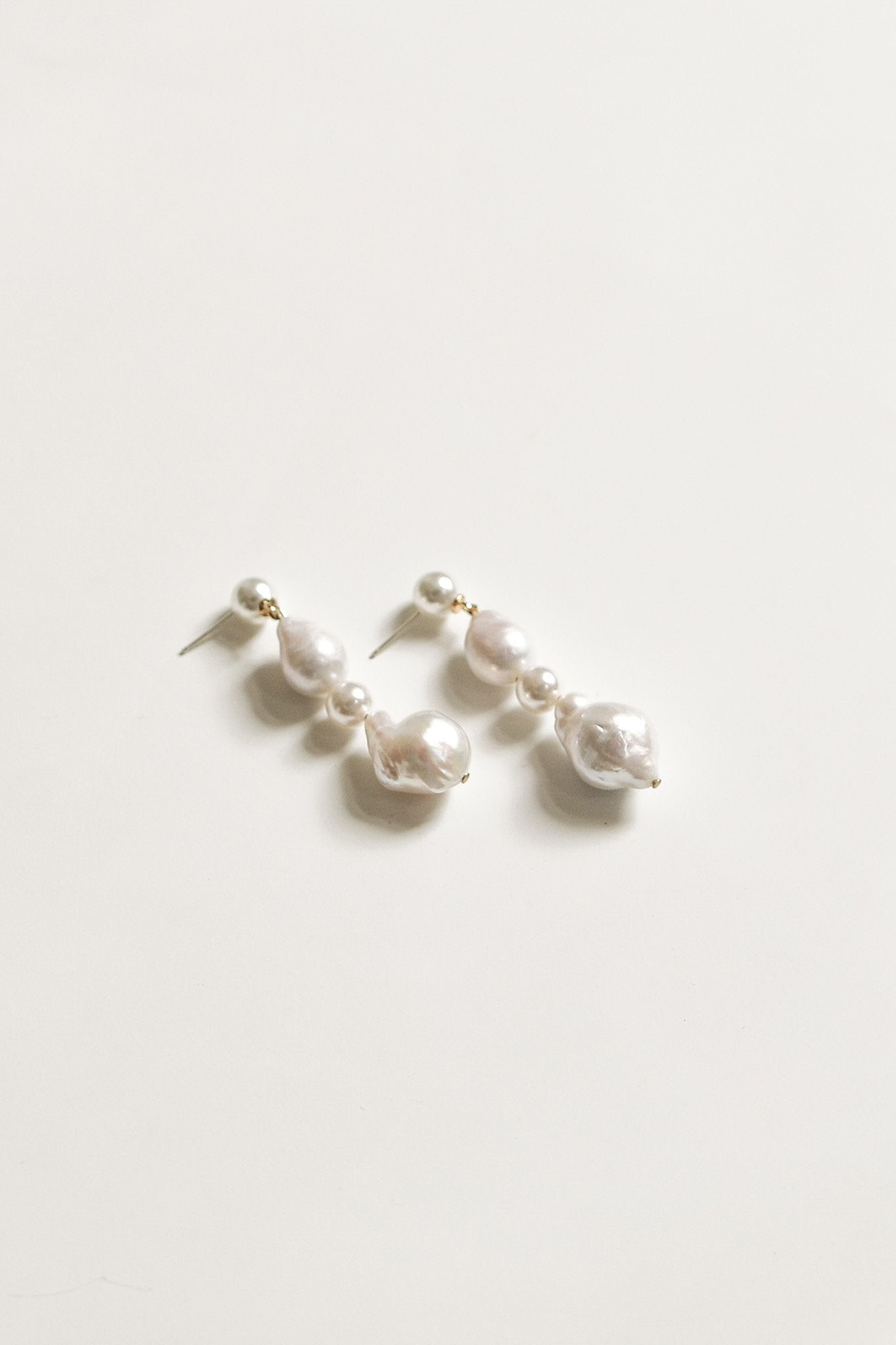 Angled Flat image of freshwater pearl bridal drop earrings by A.B Ellie