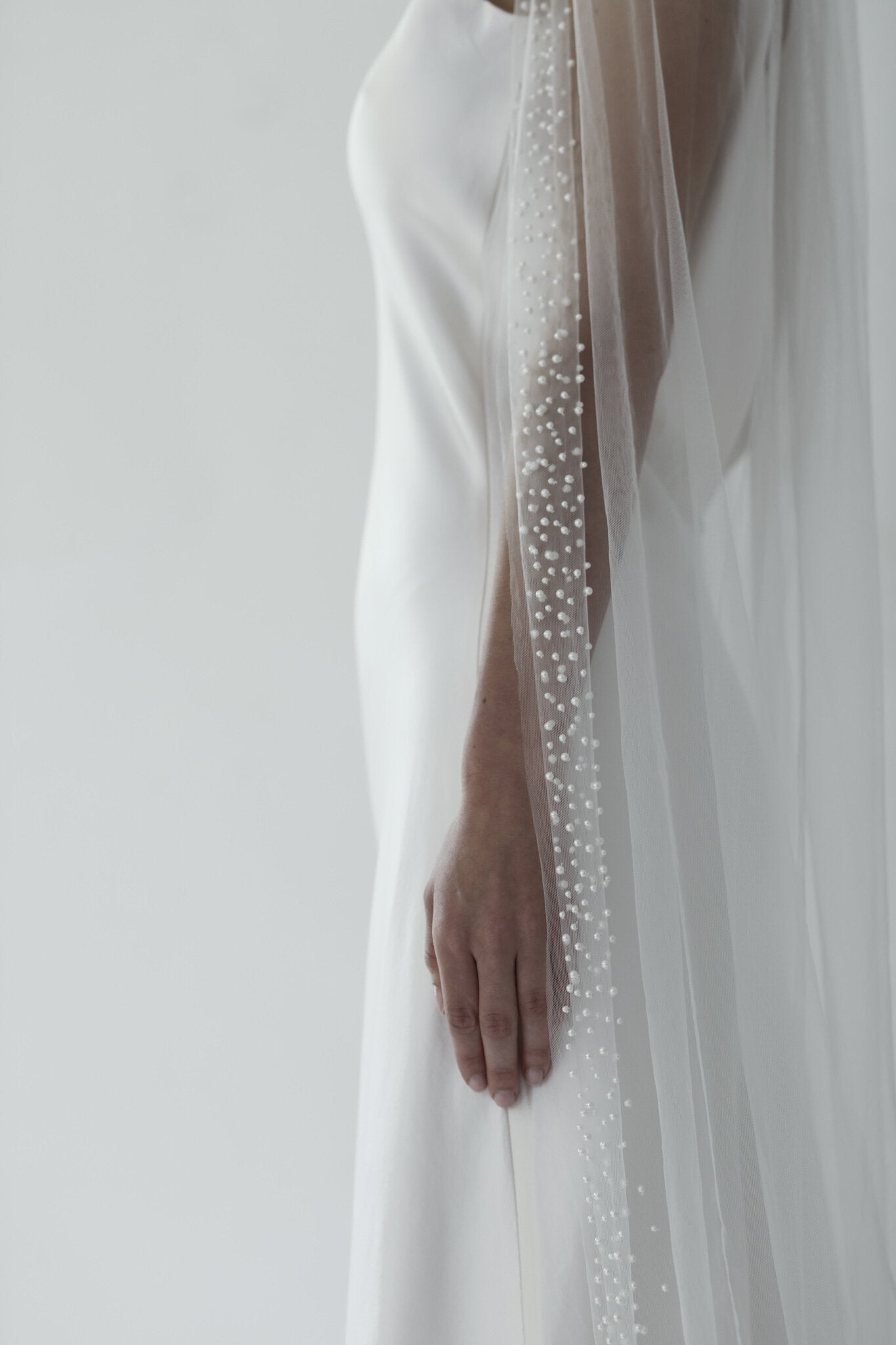 Hayden Pearl Edge wedding veil on bride wearing simple sheath wedding gown