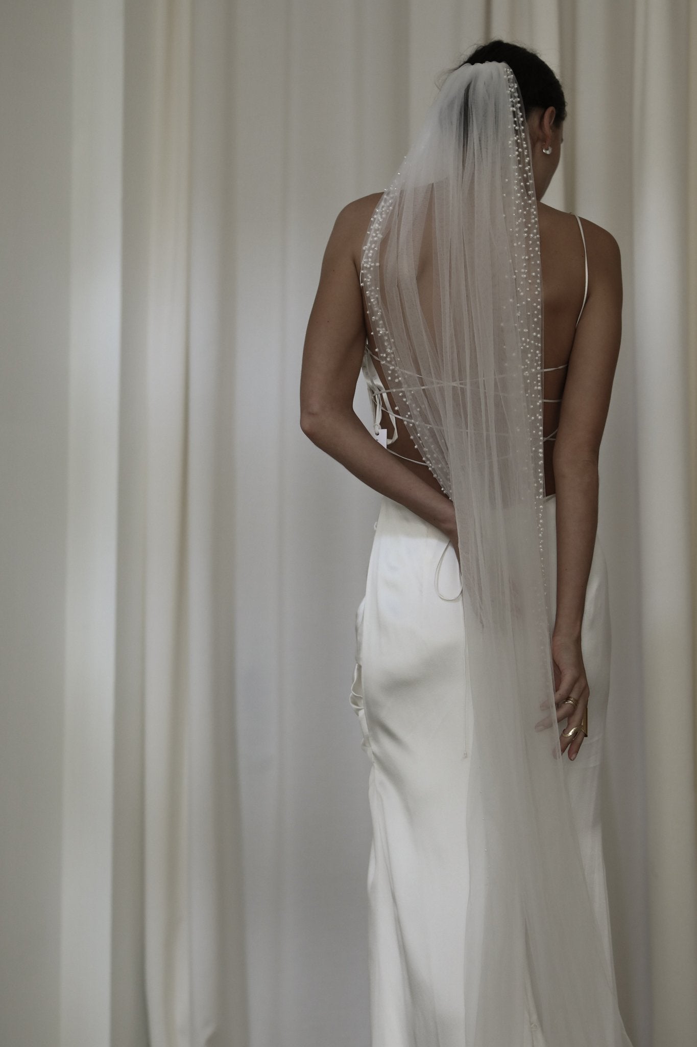 Brunette bride wearing the Hayden Pearl Edge wedding Veil with a open back wedding dress