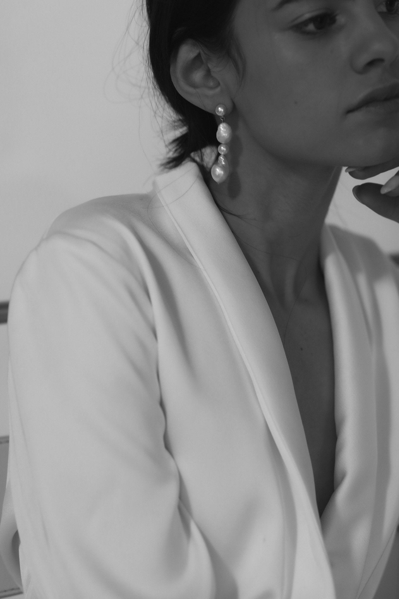 Profile view of brunette model wearing the freshwater pearl triple drop earring by A.B. Elloe