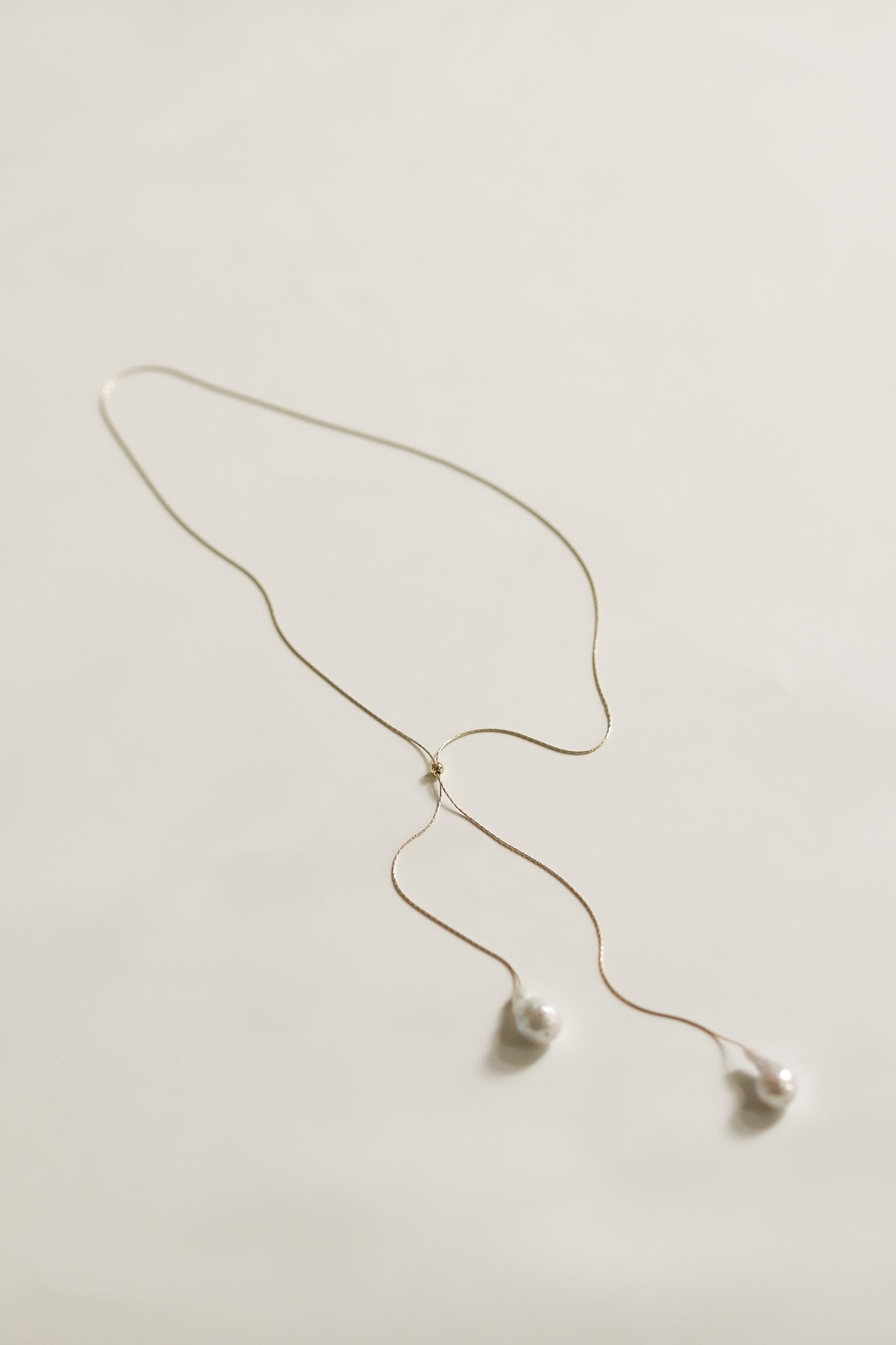 Flat view of the baroque pearl lariat necklace by AB Ellie on white background