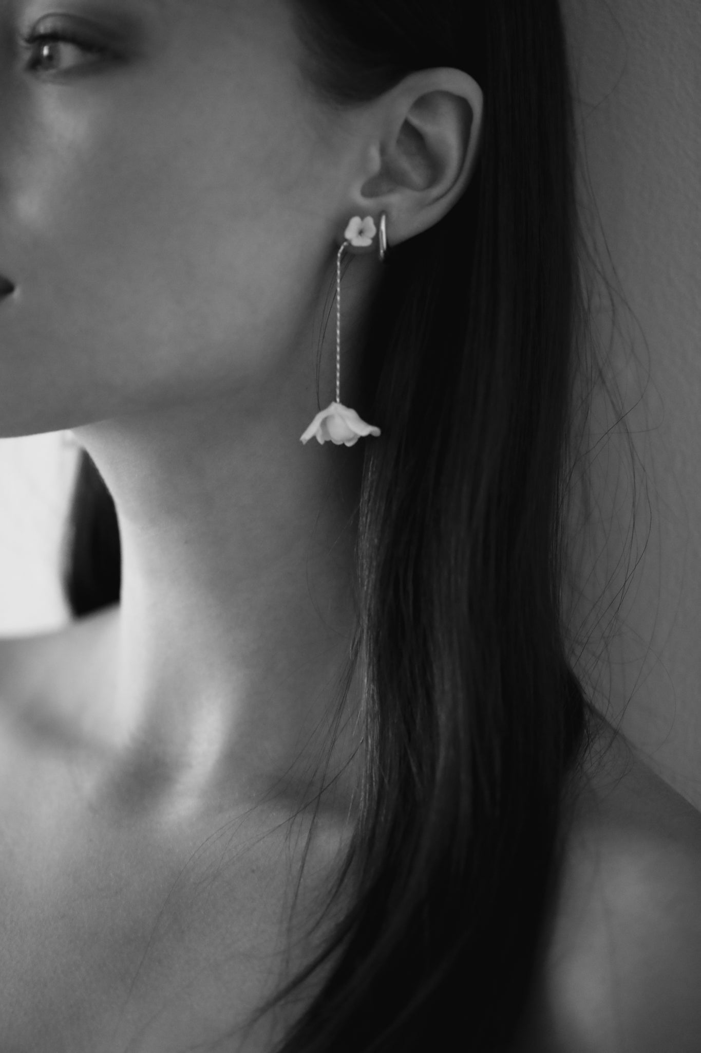 Black and white photo of bride wearing the Minimal ivory blossom strand earring by AB Ellie