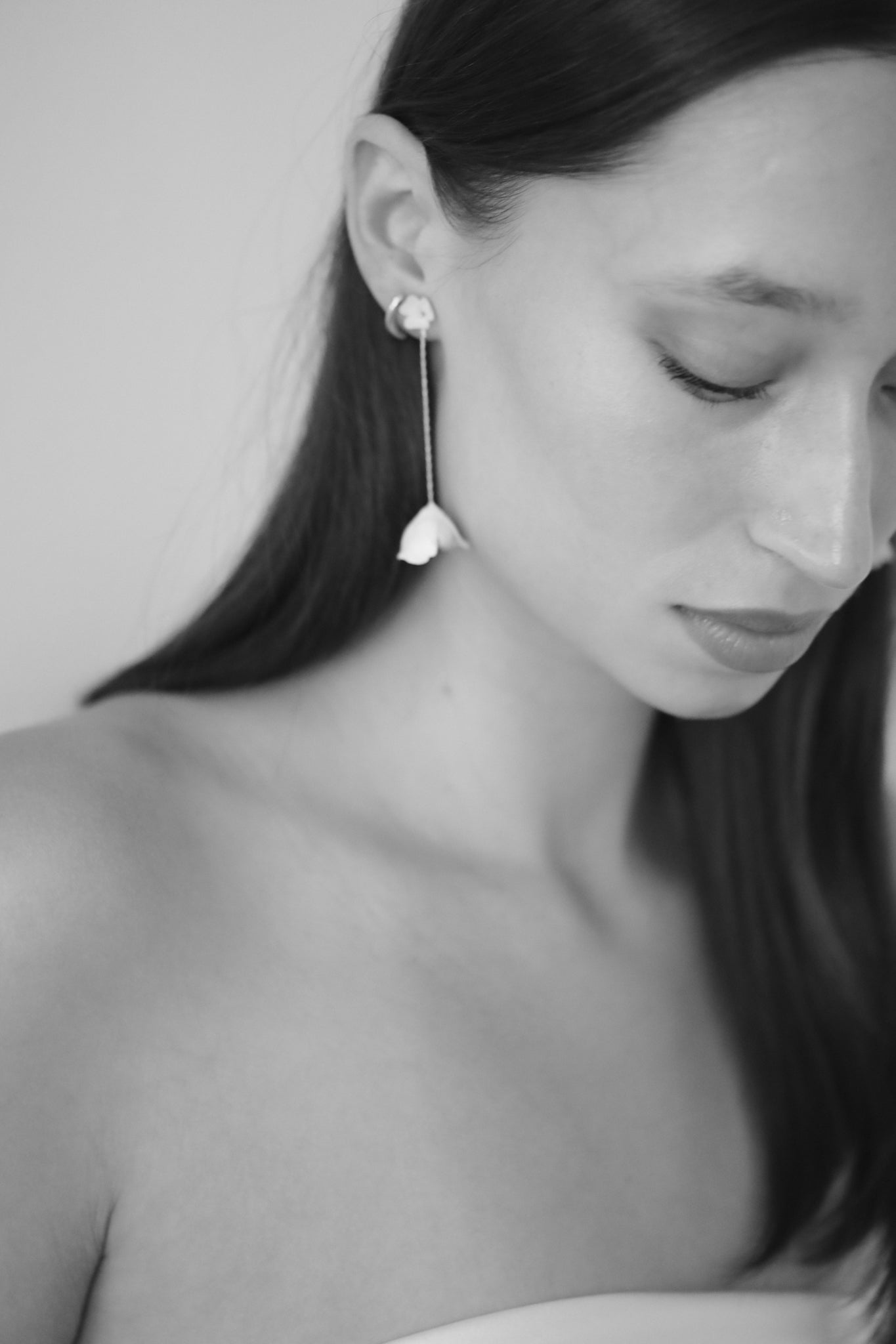Black and white photo of bride wearing the modern ivory blossom strand two-in-one bridal earring by A.B. Ellie