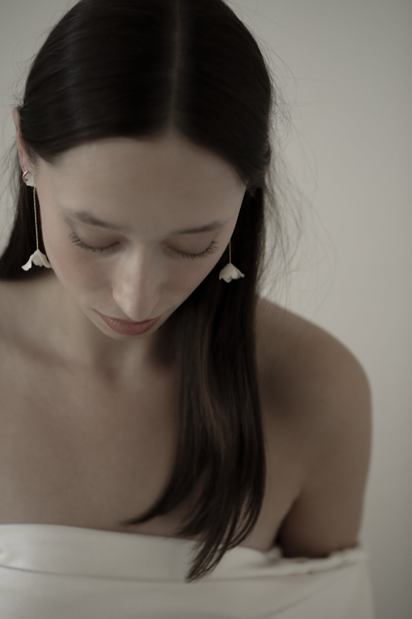 Photo of dark haired bride wearing the blossom 2 in 1 strand earrings by AB Ellie