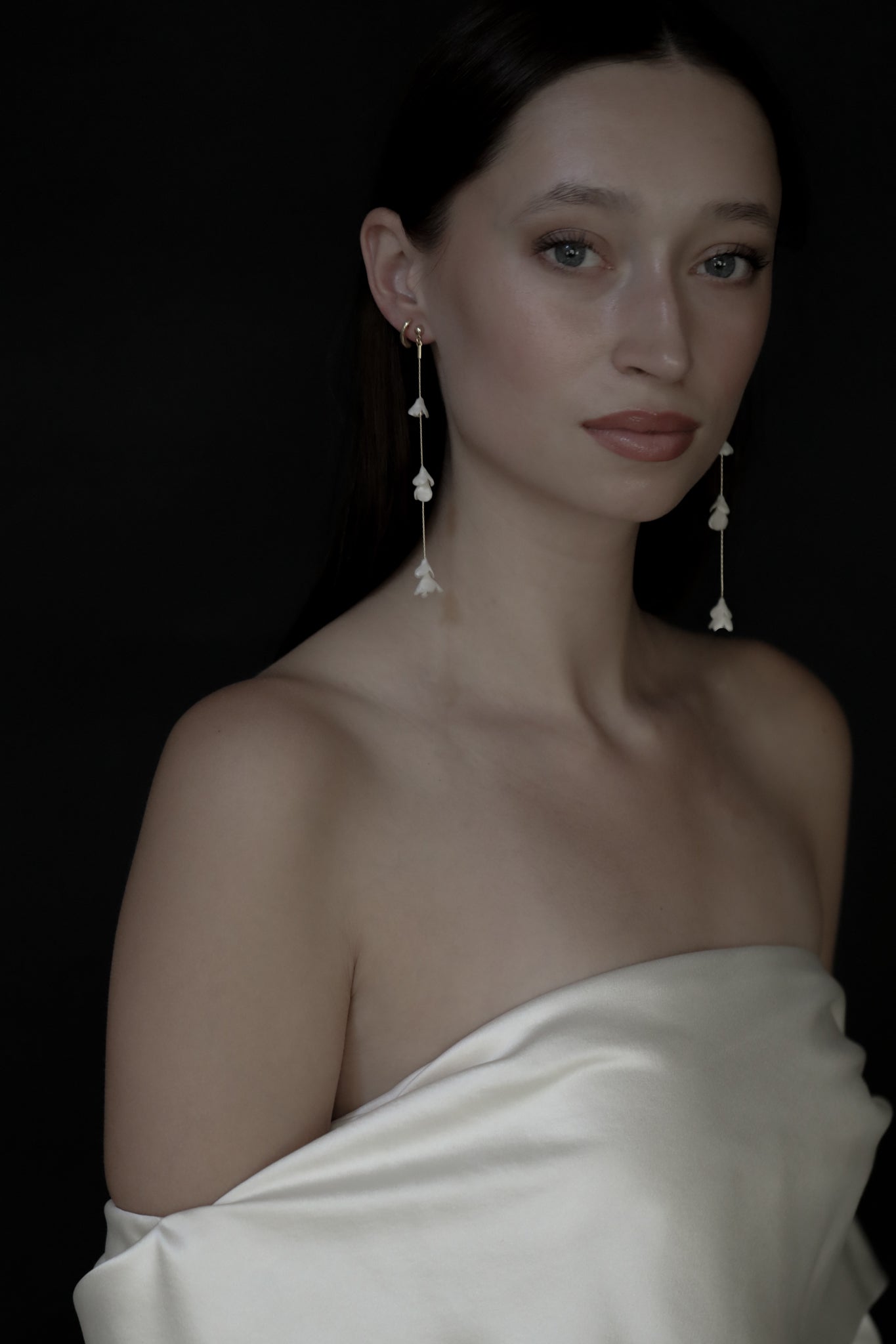 Front profile photo of bride wearing the blossom strand earrings by AB Ellie