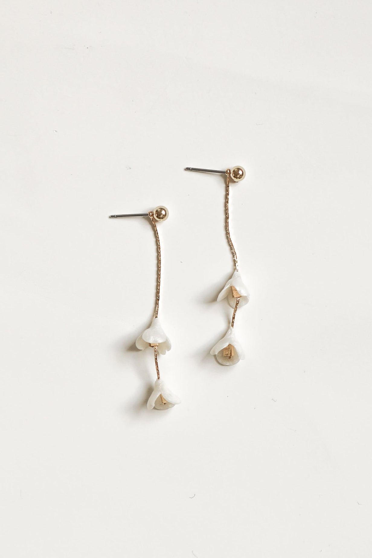 Flat photo of the blossom minimal strand earrings by AB Ellie on white background