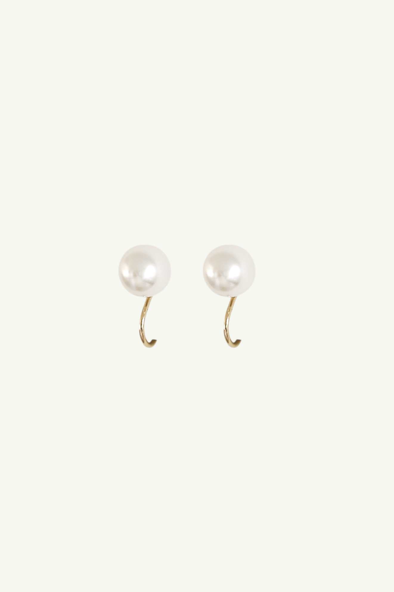 Flat photo of the pearl stud clip on earrings by AB Ellie on a white background