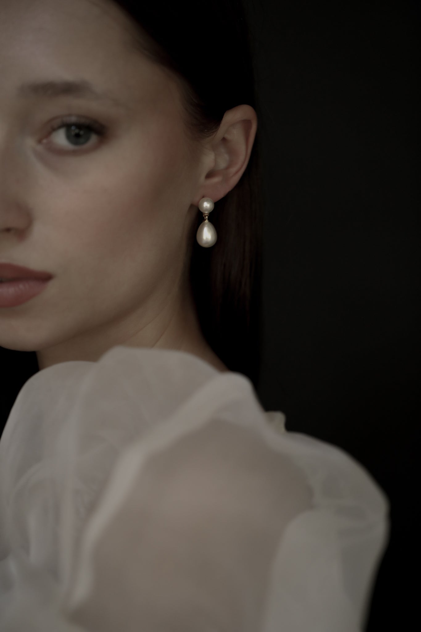 Gold Pearl double drop earrings on brunette model