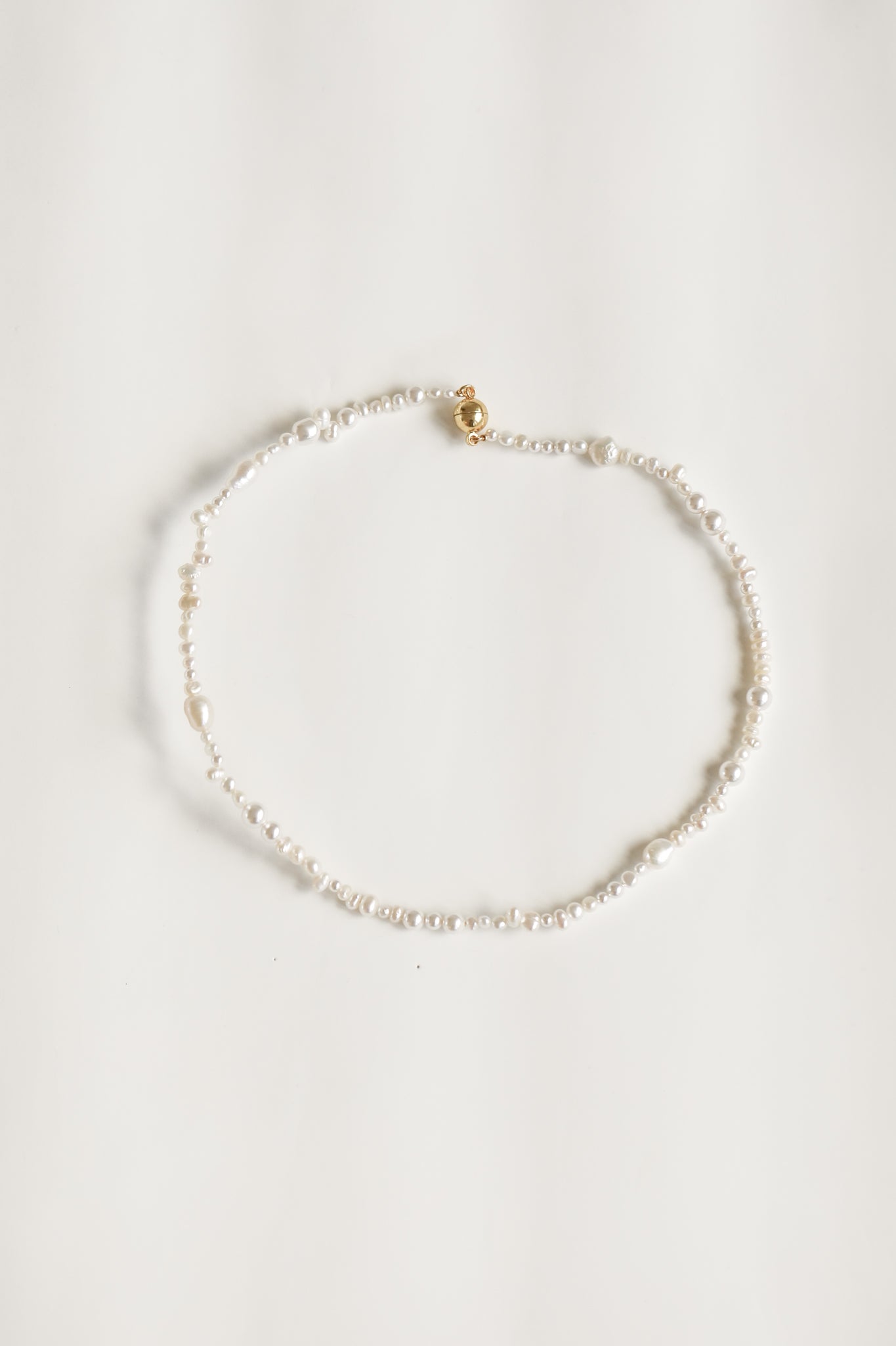 Flat photo of single strand freshwater pearl necklace by AB Ellie on white background
