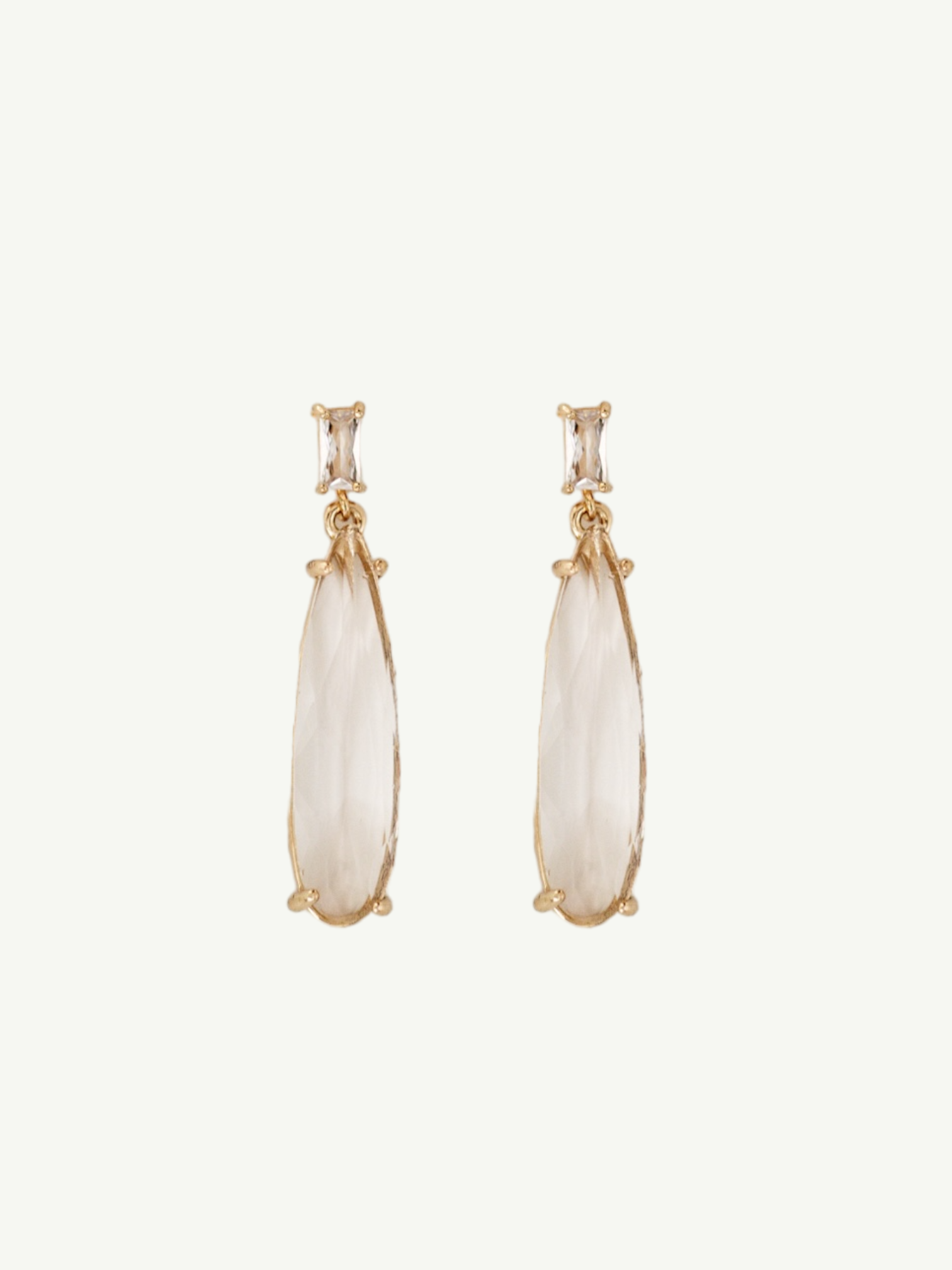 Flat photo of the gold baguette ewdrop earrings by AB Ellie on white background