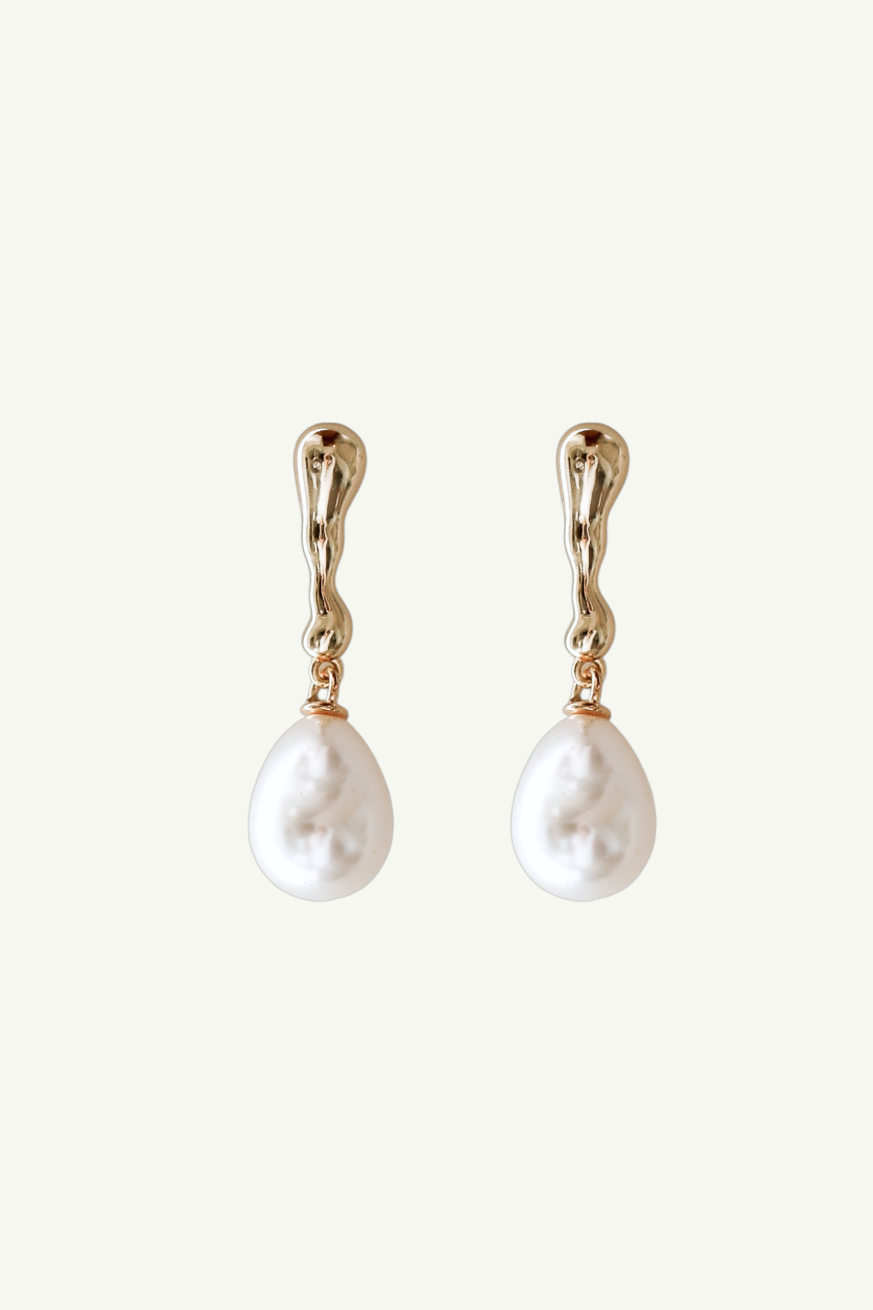 Flat phot of the gold sculptural pearl drop earrings by AB Ellie on white backgound