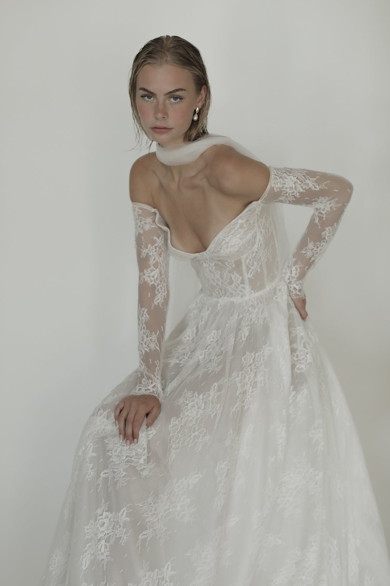 Blonde bride wearing the irregular gold pearl drop earrings by AB Ellie worn with a lace wedding dress