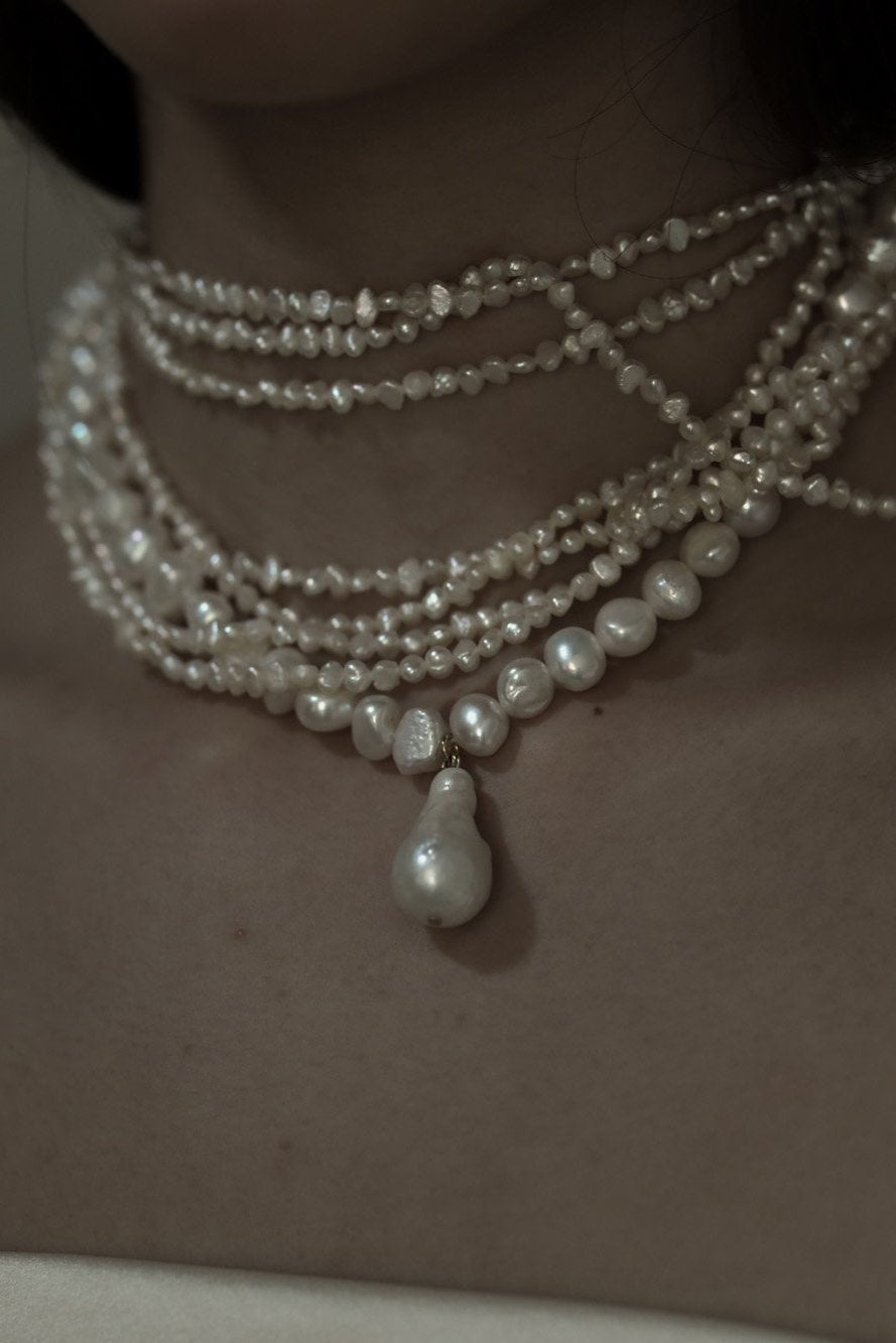 Close up view of bride wearing the layered freshwater pearl necklace by AB Ellie