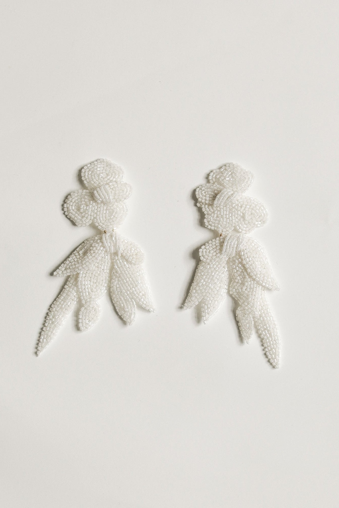 Flat photo of the Maj Drop earrings in ivory by AB Ellie on white background