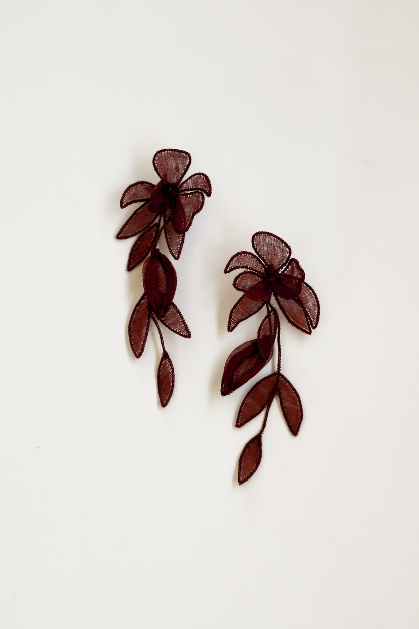 Flat photo of the mini charlee tier earrings in burgundy by AB Ellie on white background