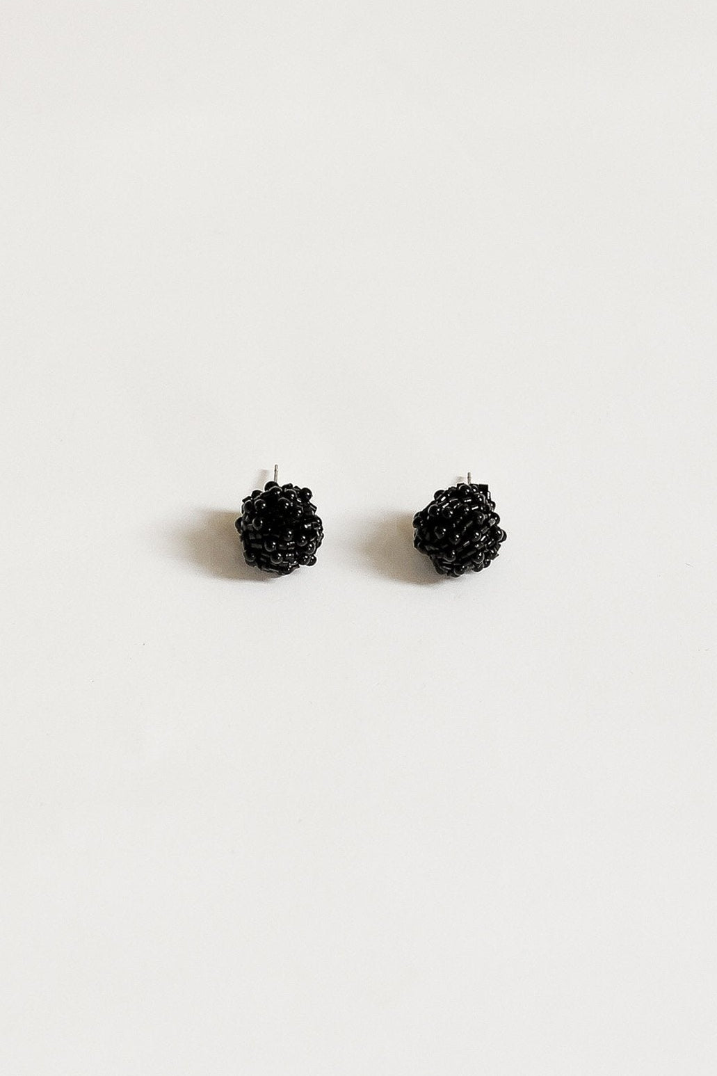 Flat image of the Black Celine Stud with knotted synthetic beading in a stud earring