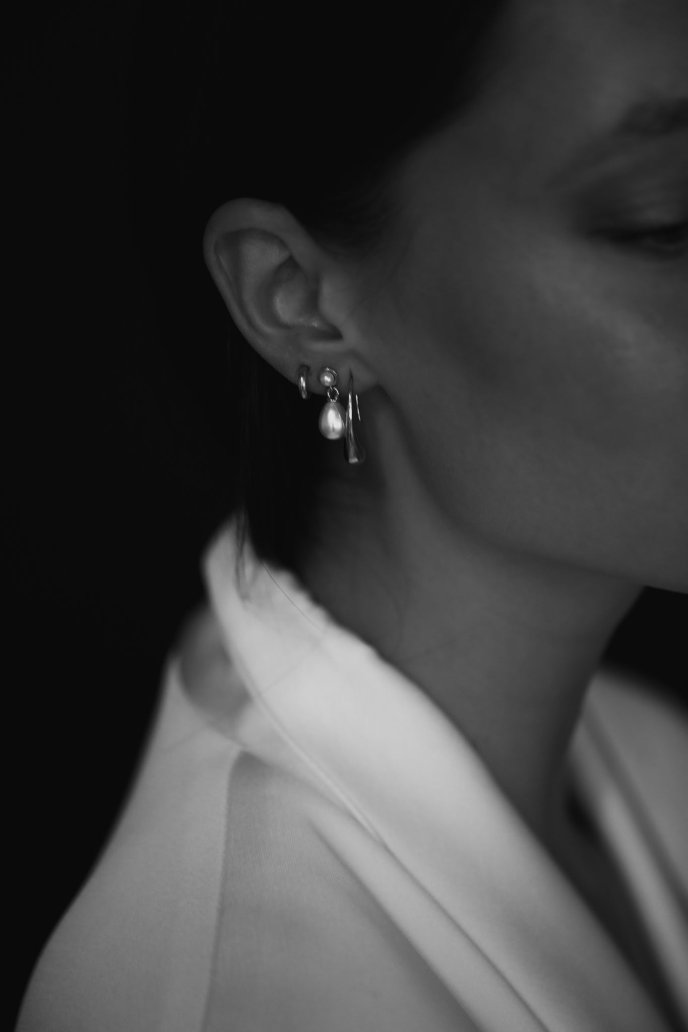 Side profile photo of dark haired bride wearing the pearl micro drop earrings with 3 piercings by AB Ellie Studio Bride collection