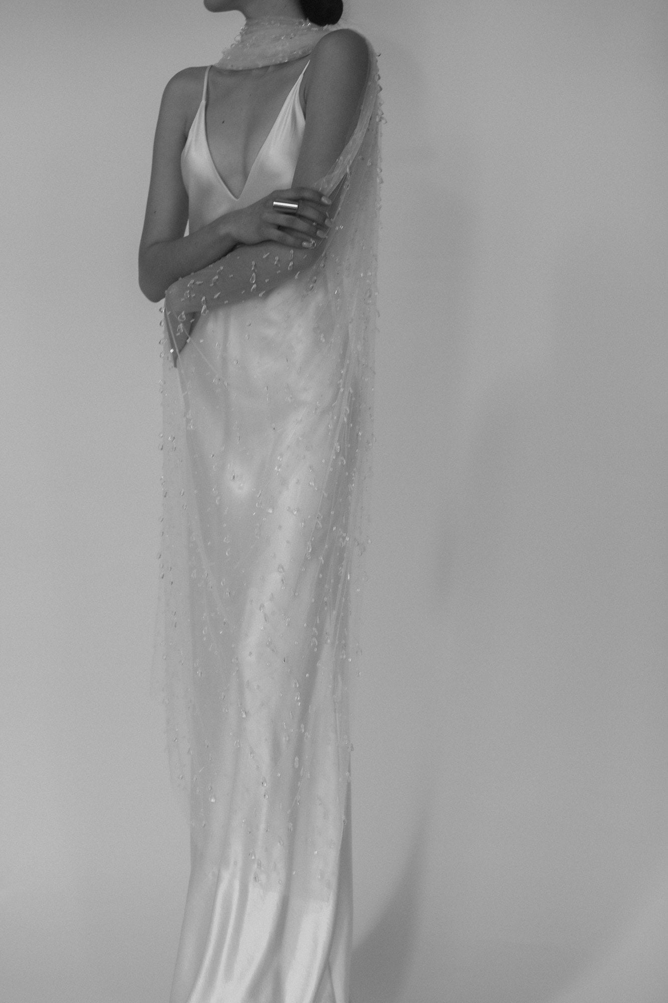 Black and white photo of Bride wearing the Rain glass wedding veil by AB Ellie