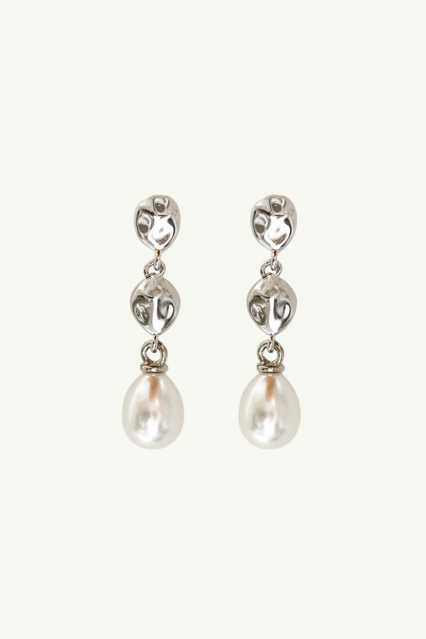 Flat image on white background of silver gilded tier drop earrings with bridal pearl drop earring accent