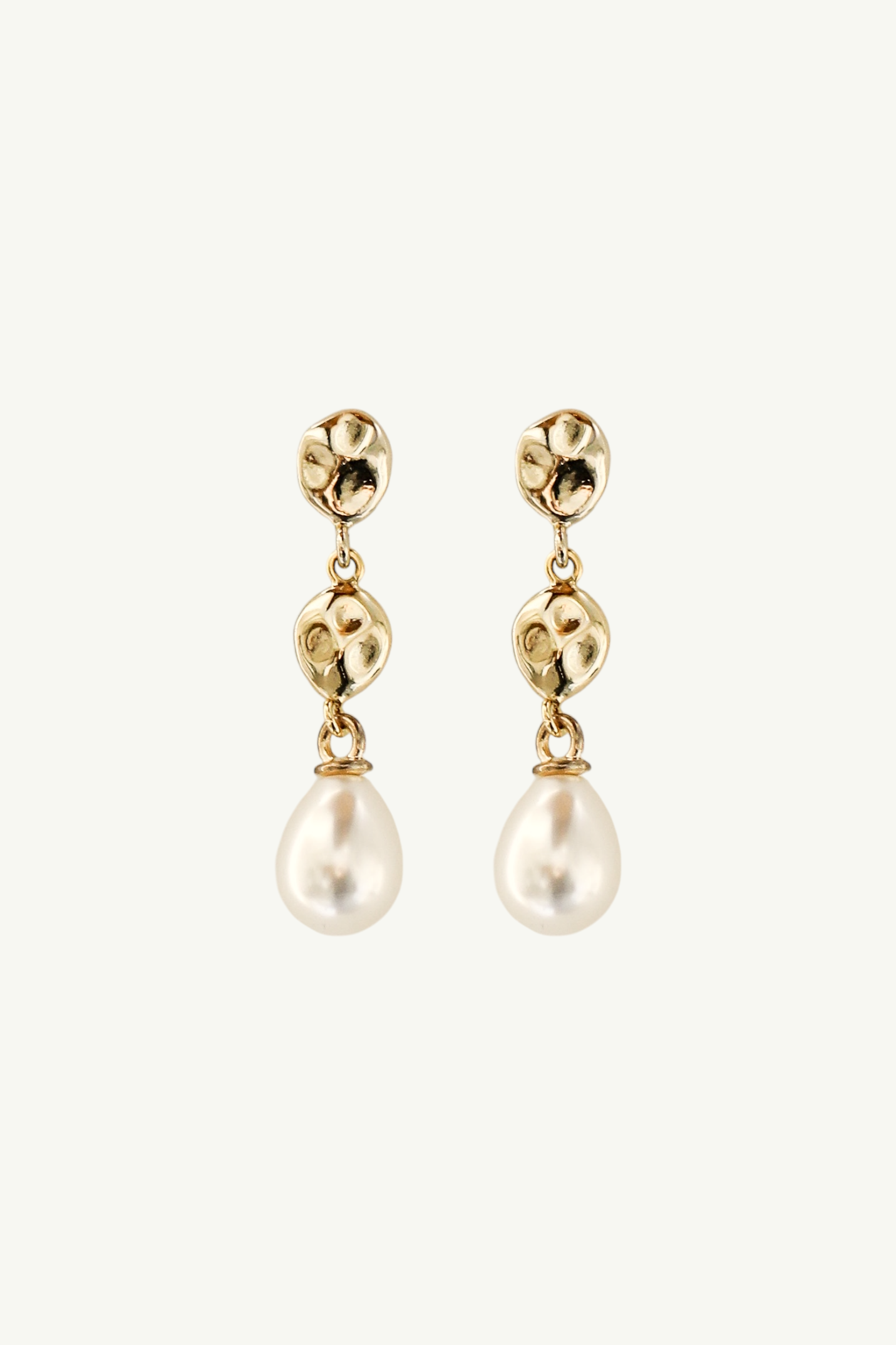 Flat image on white background of the gold sculptural tier drop earrings with classic pearl drop accent