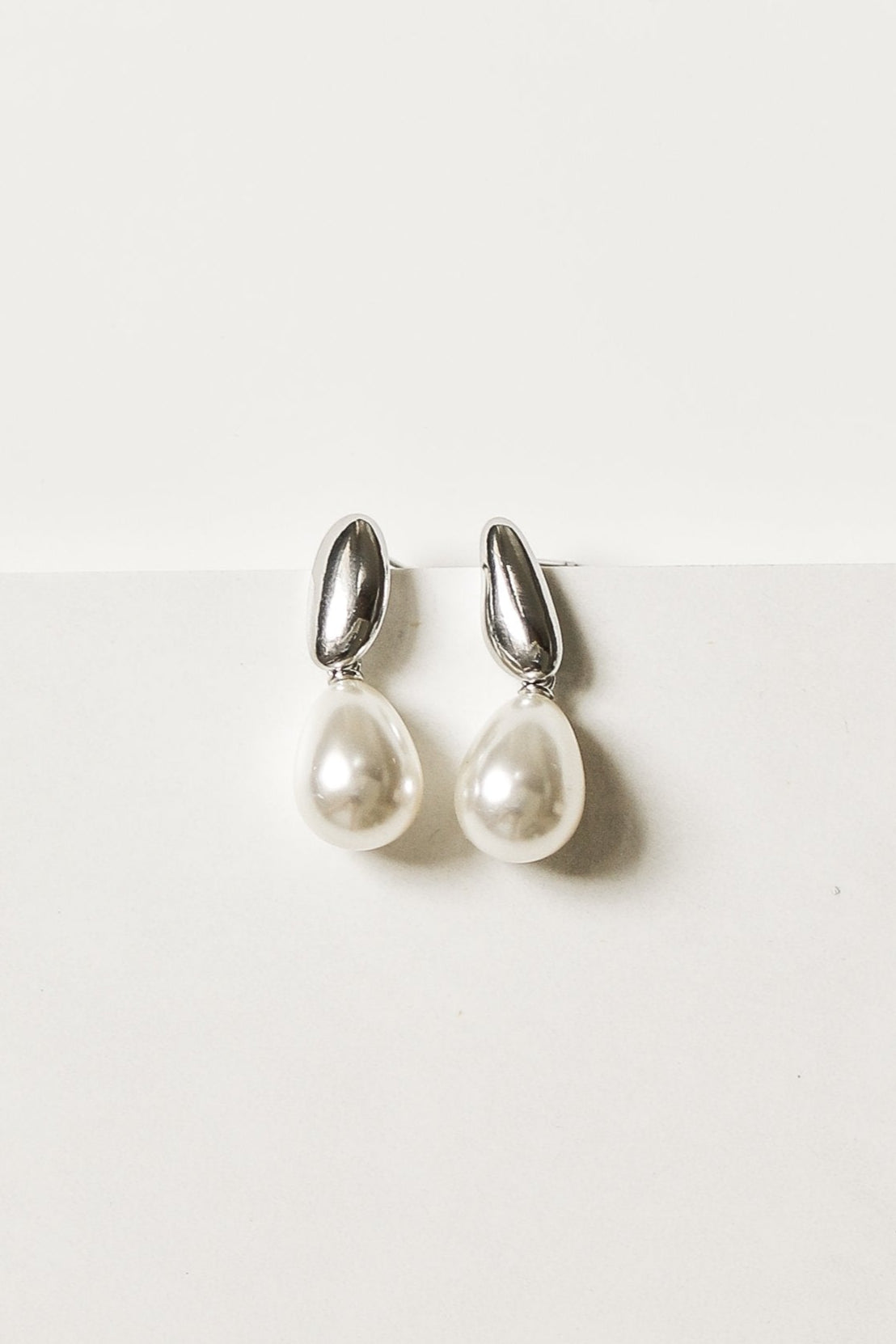 Silver and pearl drop earrings by AB Ellie on a white background