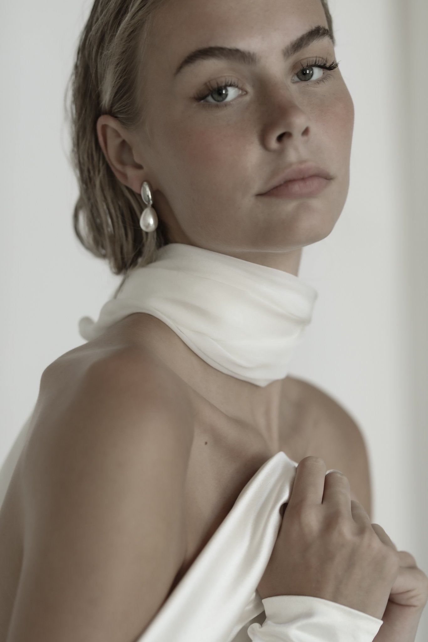 Blonde bride wearing silver pearl drop earrings by AB Ellie with a silk scarf and strapless wedding dress.