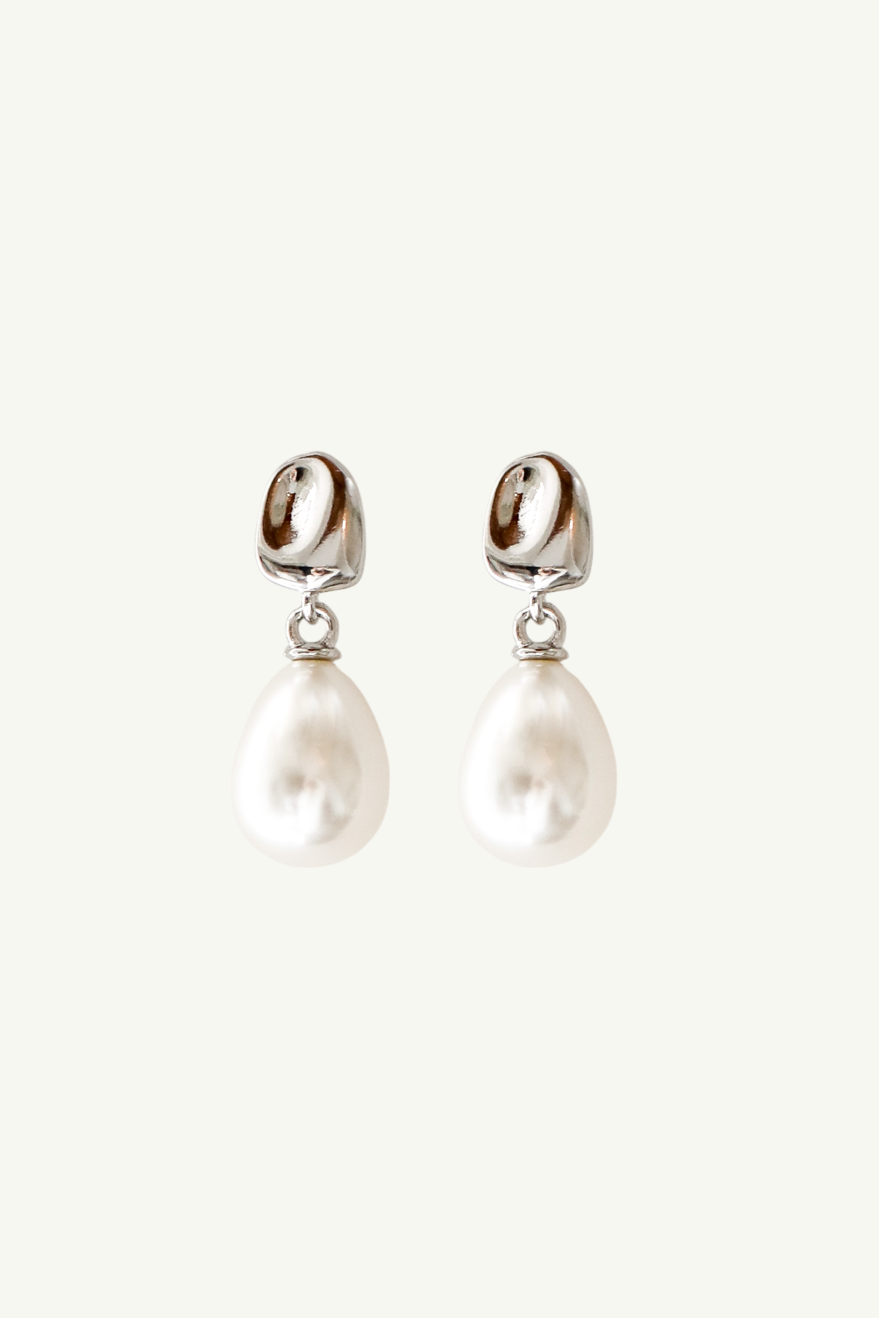 Flat photo of the silver orb mini pearl drop earrings by AB Ellie