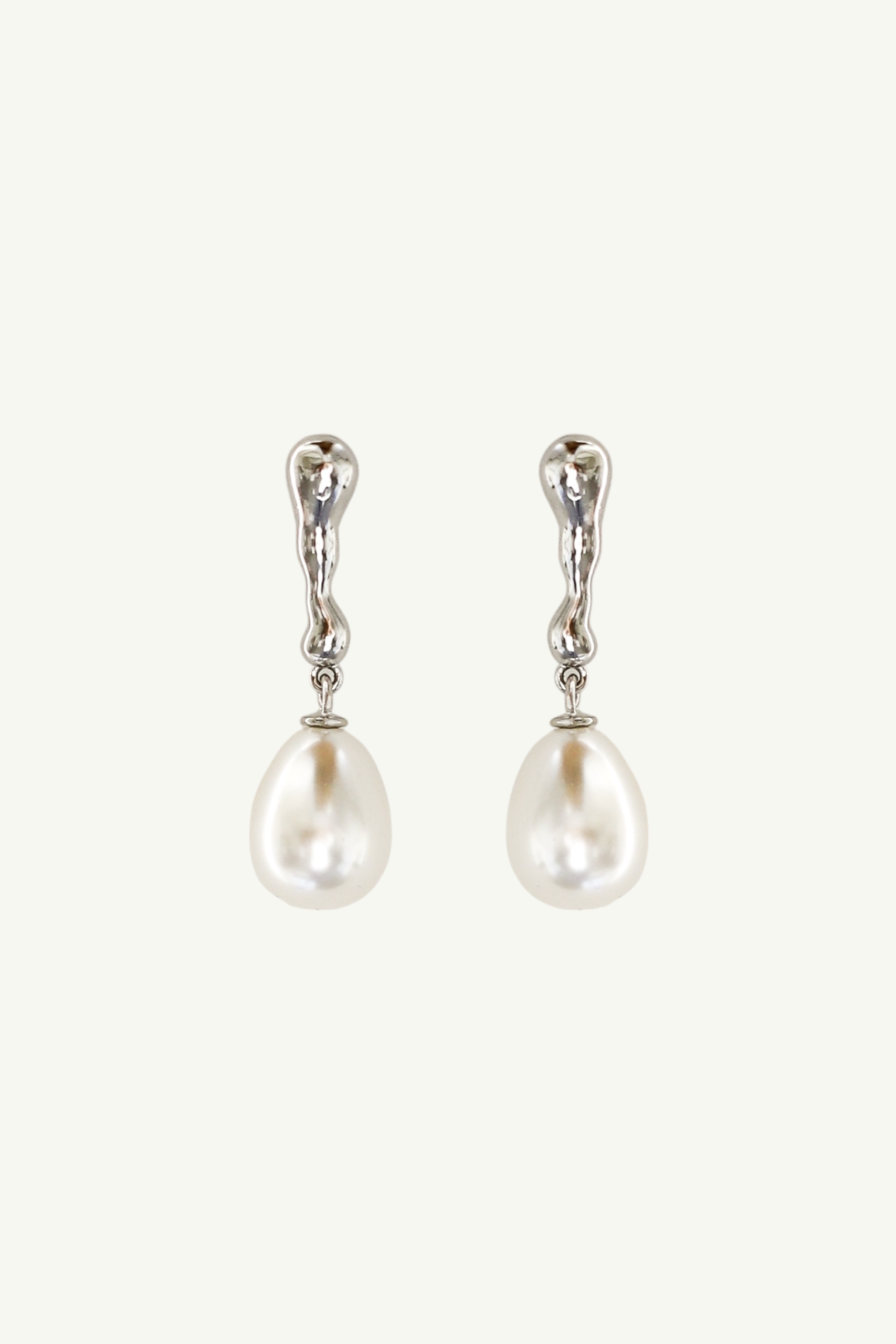 Flat phot of the silver sculptural pearl drop earrings by AB Ellie on white backgound