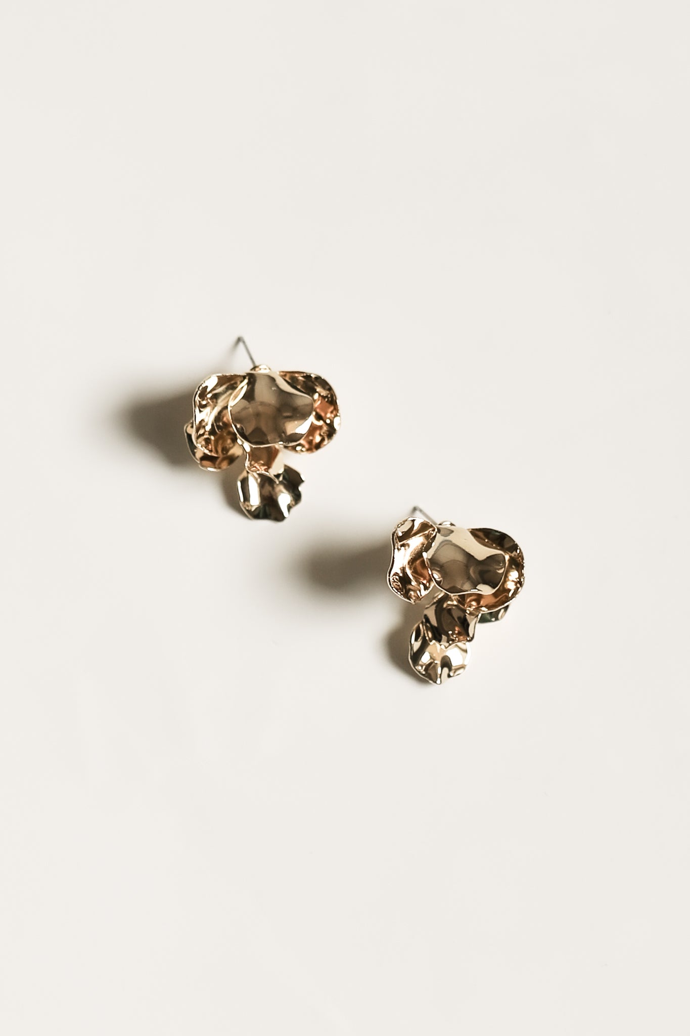Flat photo of the small Remy gold drop earrings by AB Ellie on white background