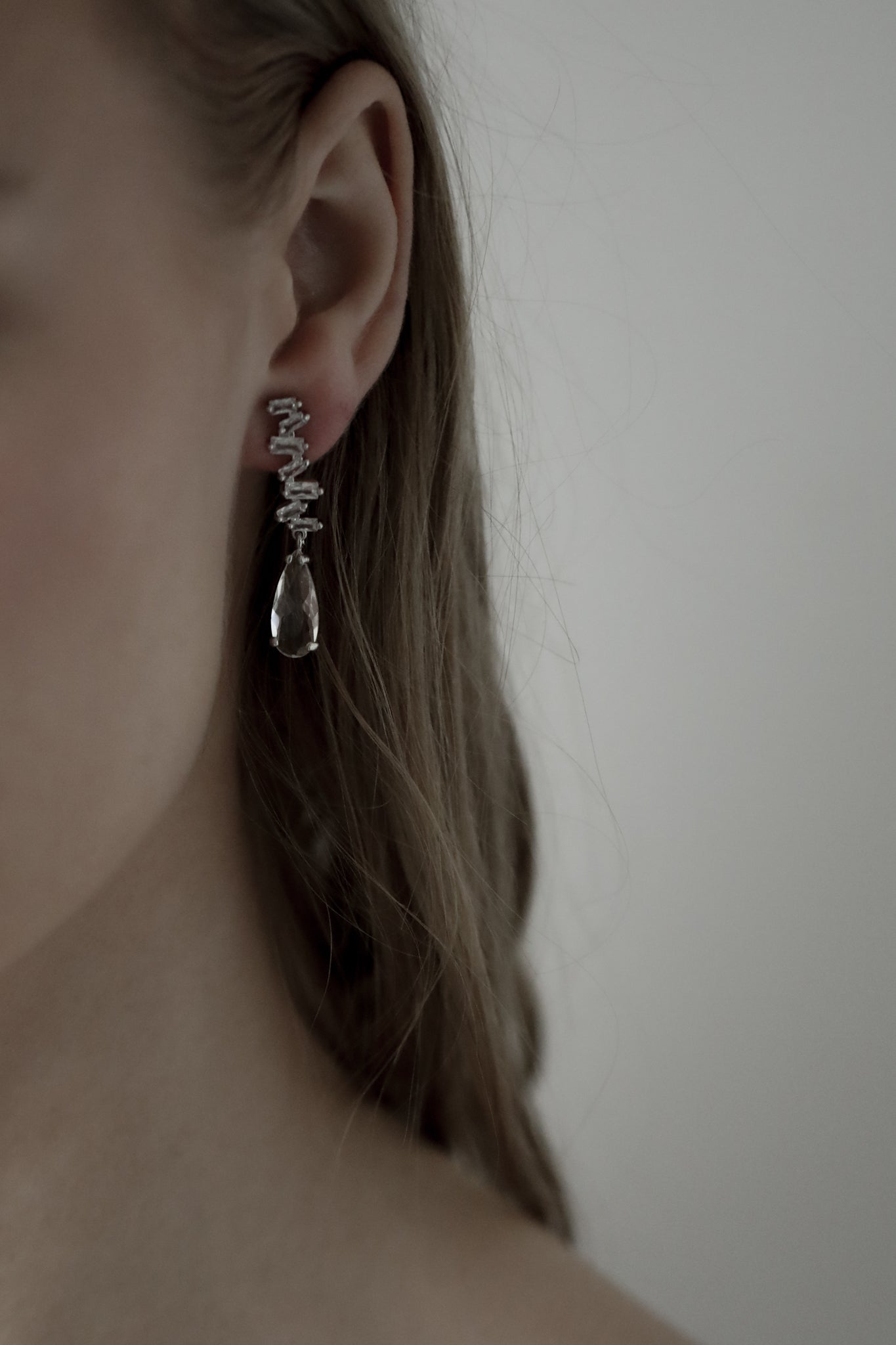 Stacked rhinestone and crystal drop earring worn by a bride with brunette colored hair