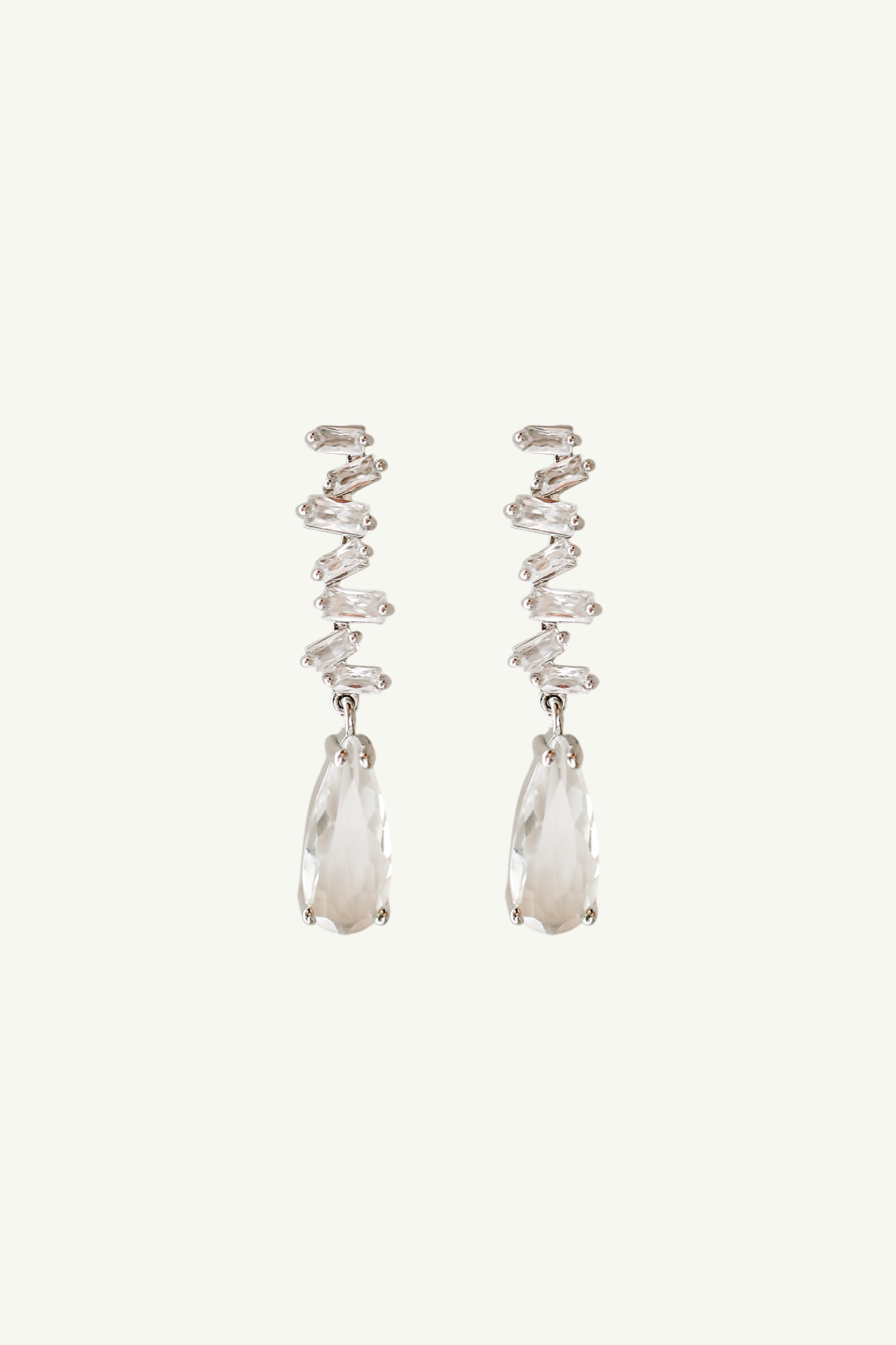 Flat image of stacked baguette rhinestone earrings featuring a larger crystal drop at the bottom of each earring