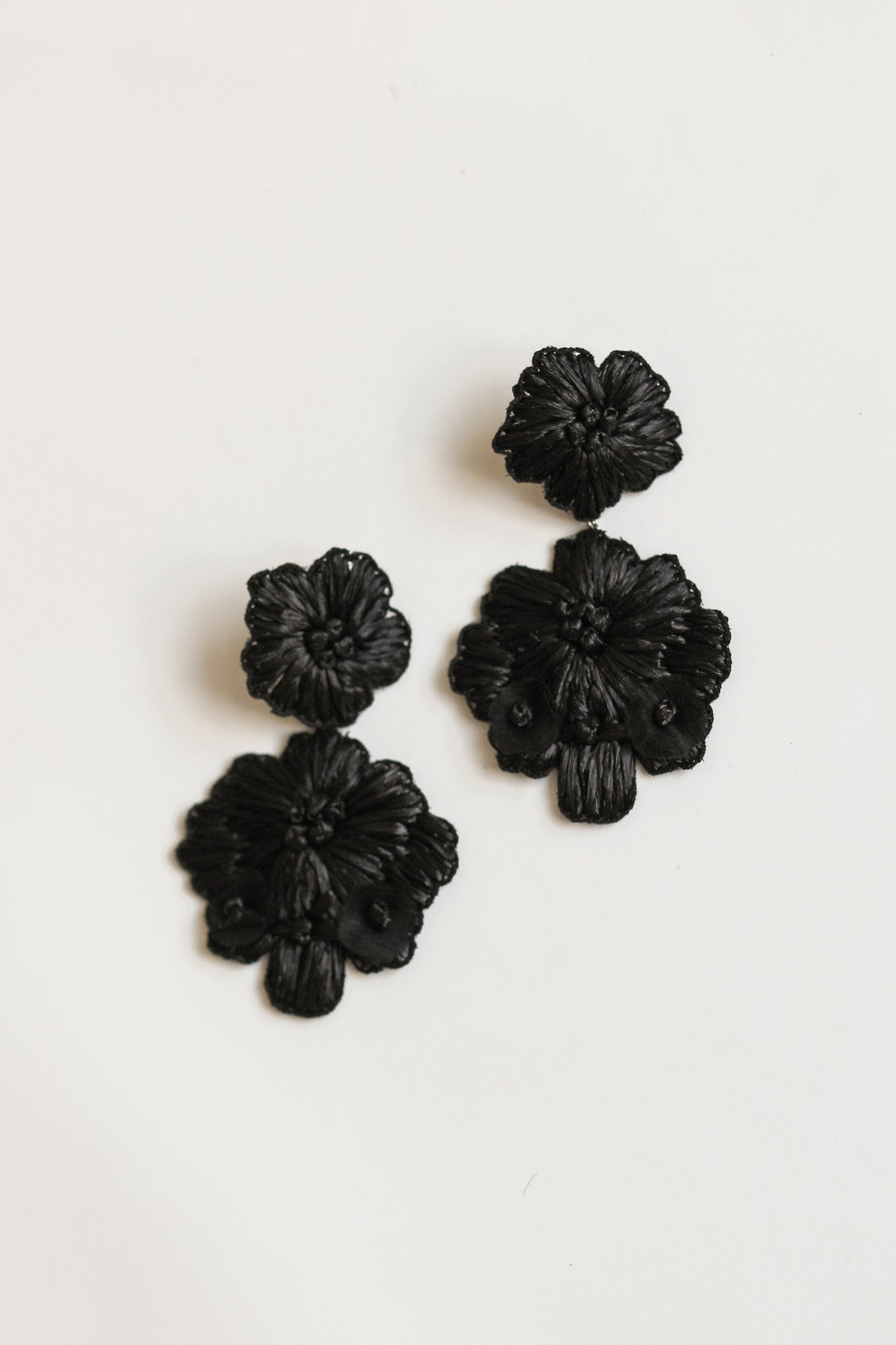 Flat image of the Stevie florarl statement earrings by A.B. Ellie on white background
