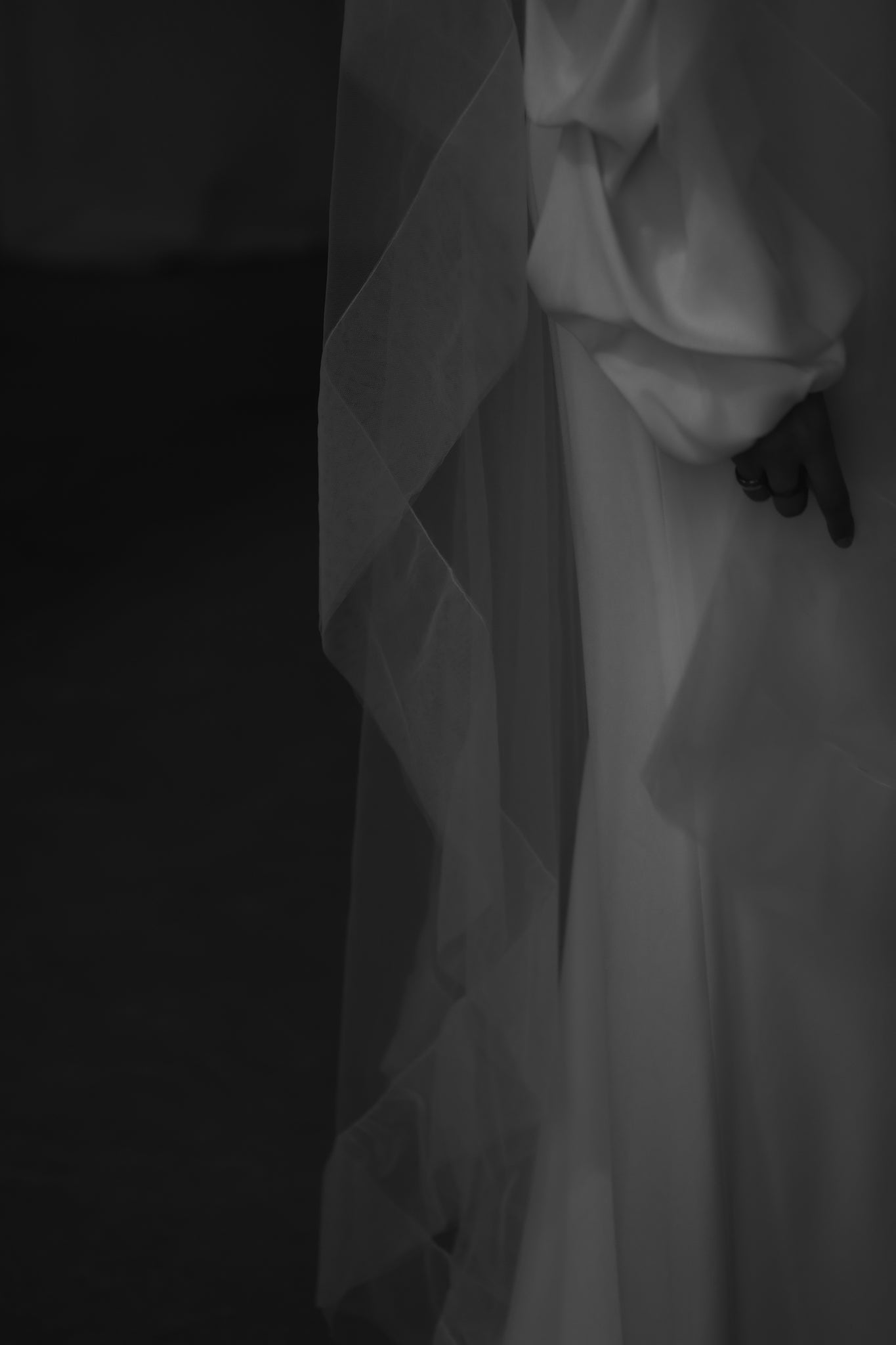 Side up close detail of the tulle edge wedding veil on black background by A.B. Ellie