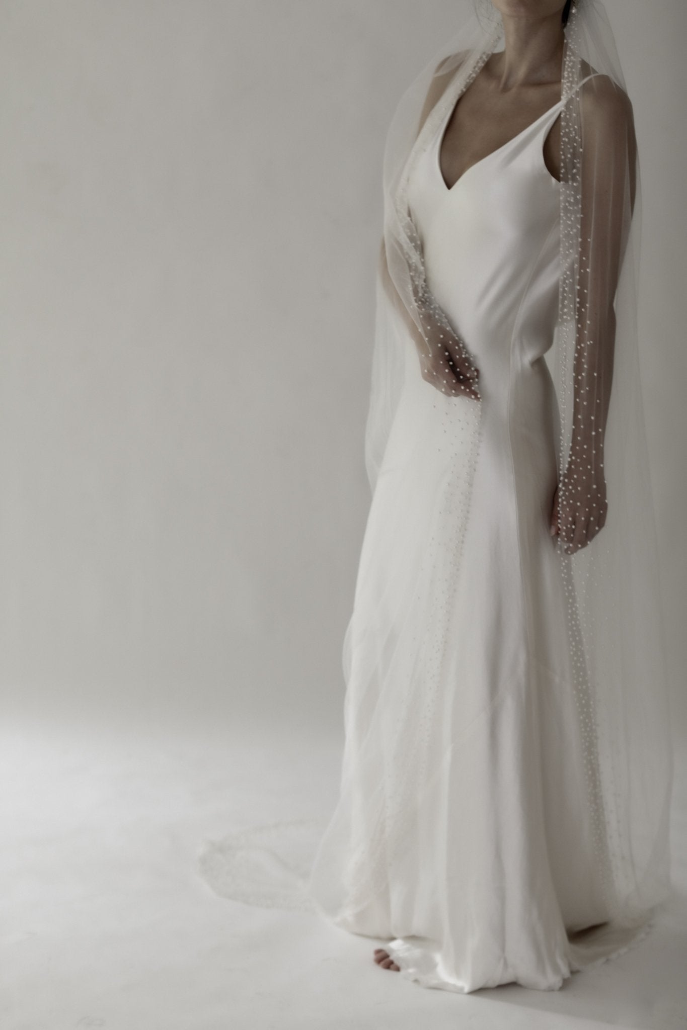 Hayden Pearl Edge Wedding Veil on model wearing sheath wedding dress