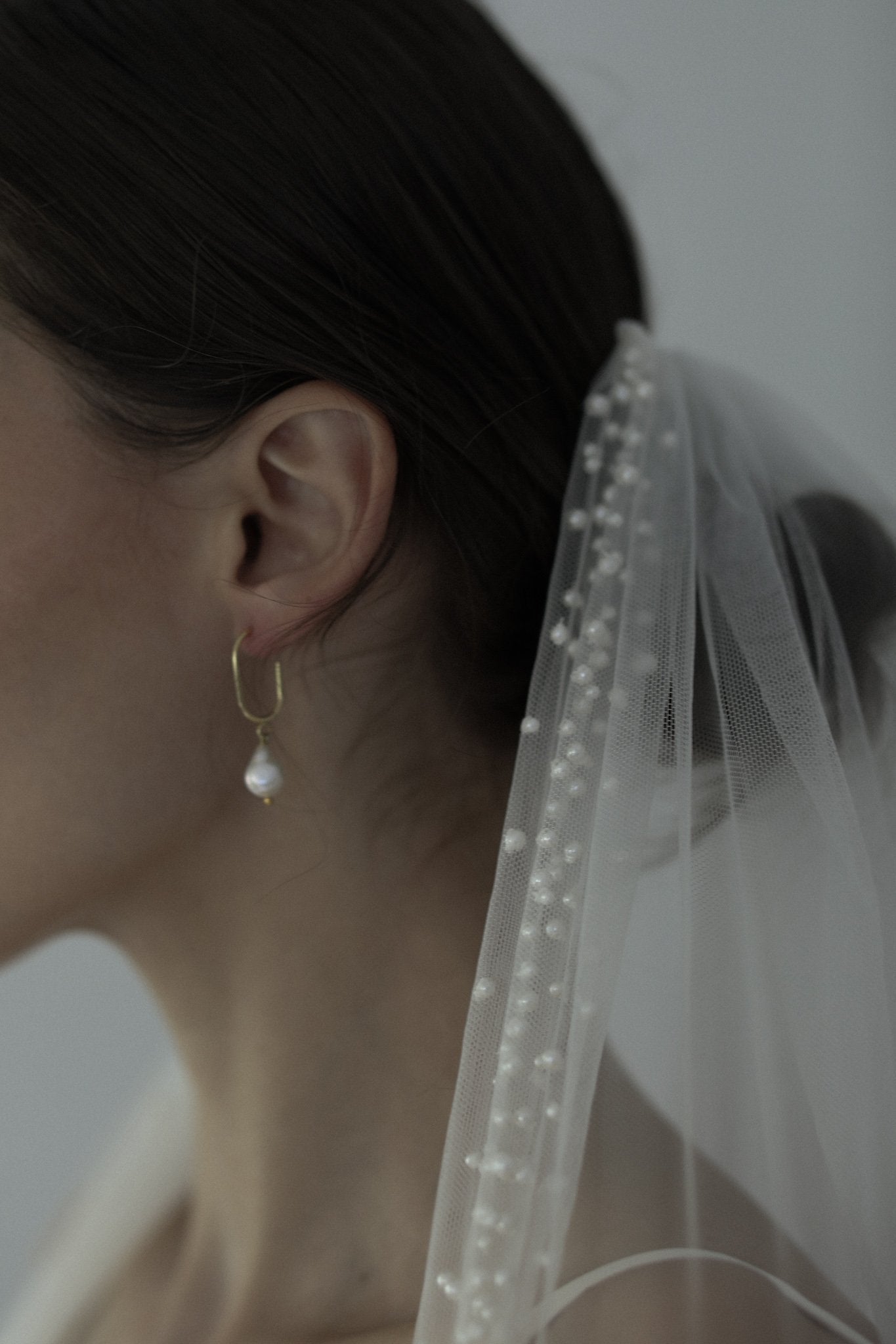 Close up of Hayden Pearl Edge Veil on brunette model also wearing freshwater pearl drop earring