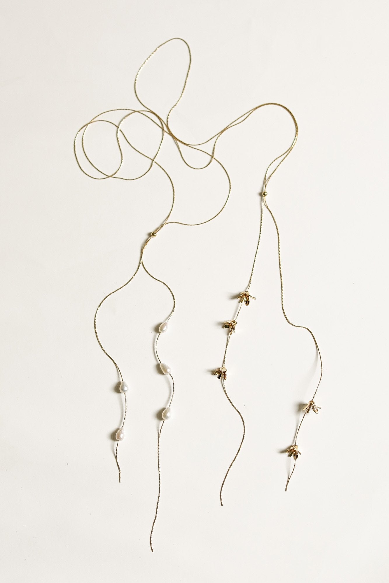 Side by side view of Perla and Rue gold lariat necklaces by AB Ellie on a white background