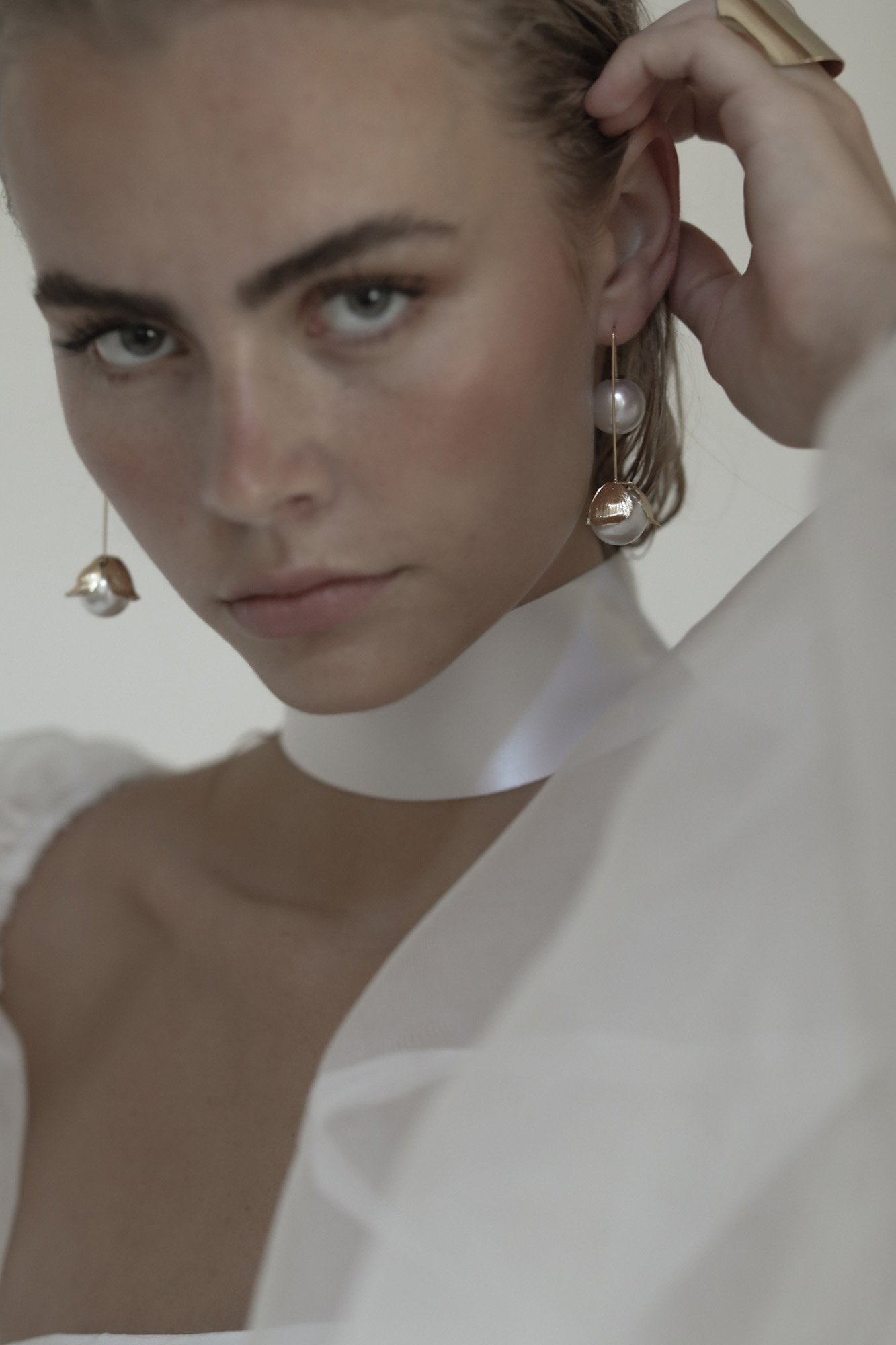 Front view of bride wearing the Bardot Pearl drop earring in gold by AB Ellie