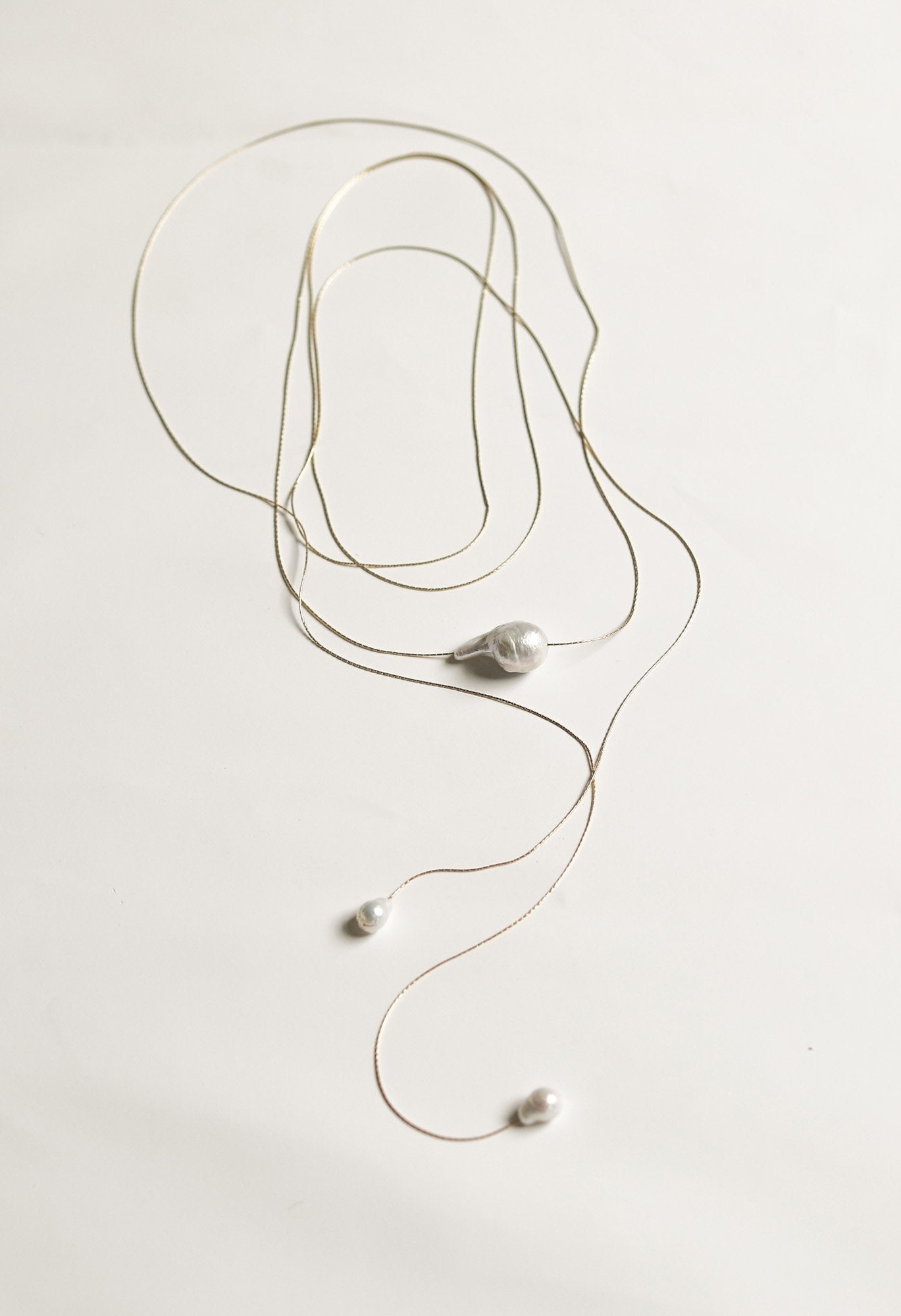 Flat image of the baroque pearl wrap lariat necklace by AB Ellie on a white background