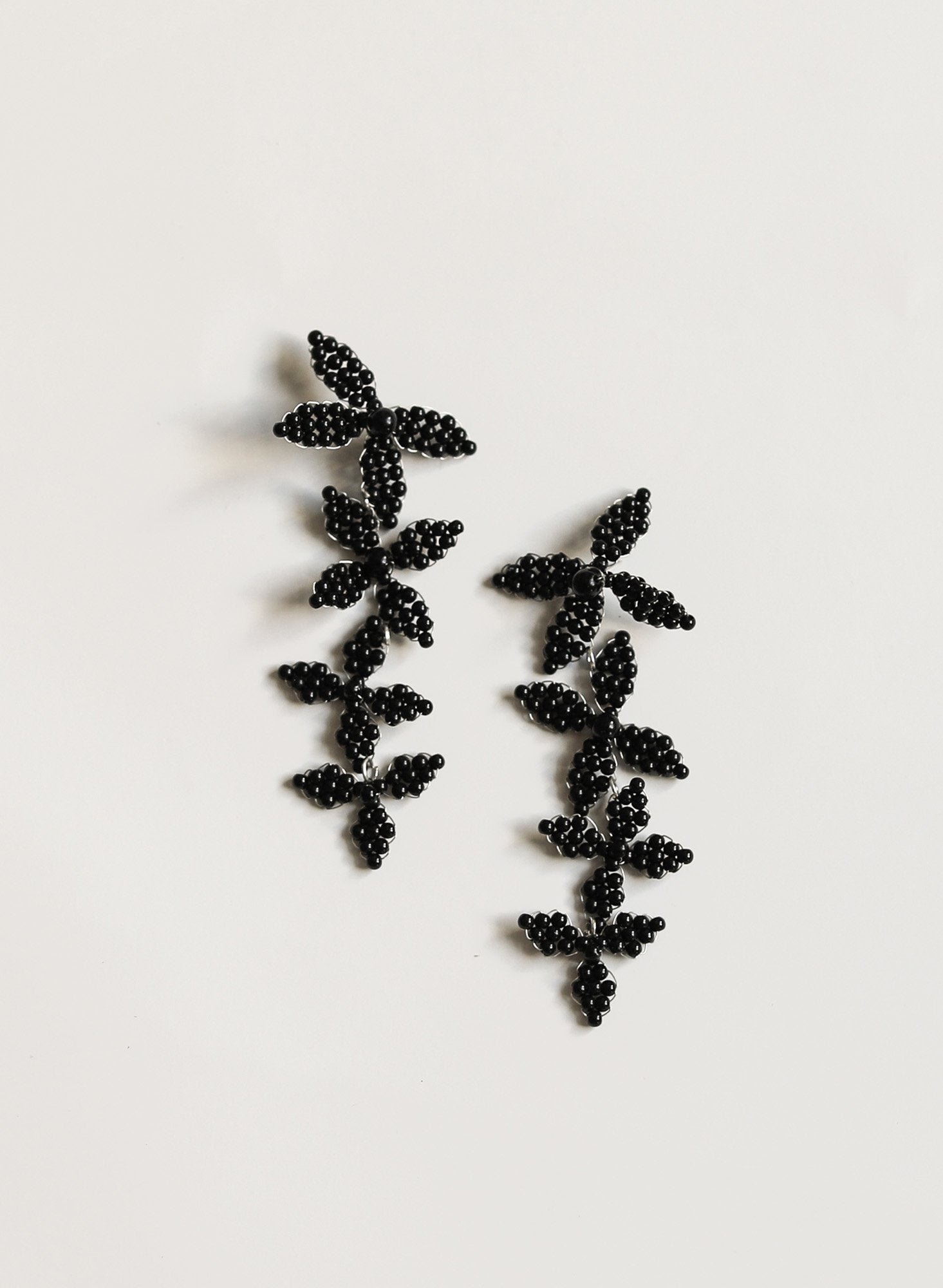 Flat image of the  beaded black Harlow earring on white background