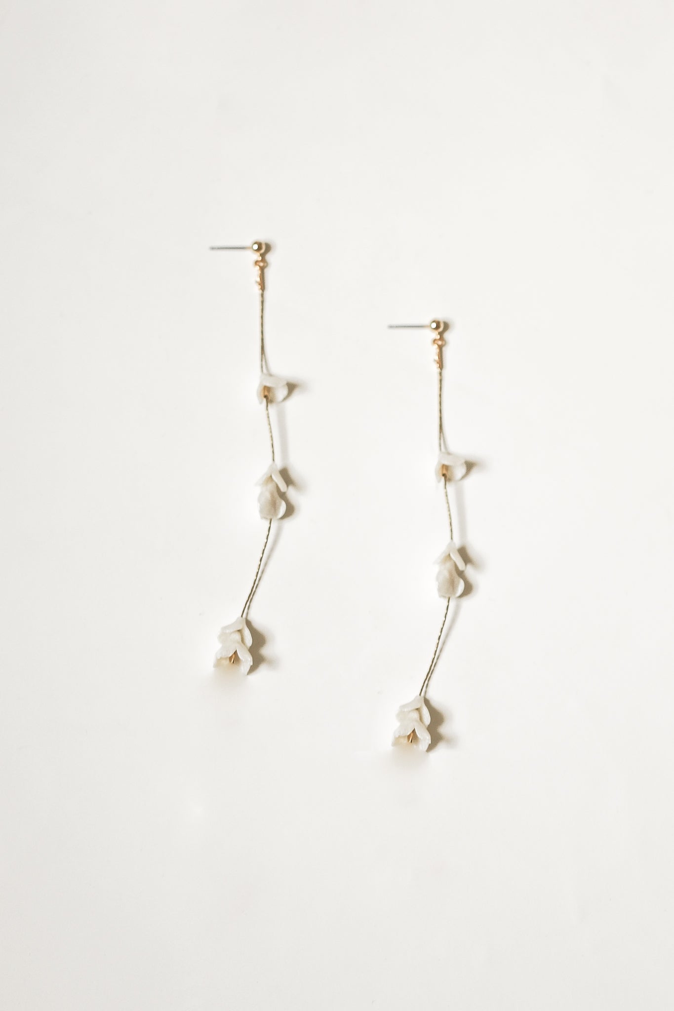 Flat photo of the blossom strand earrings by AB Ellie on white background