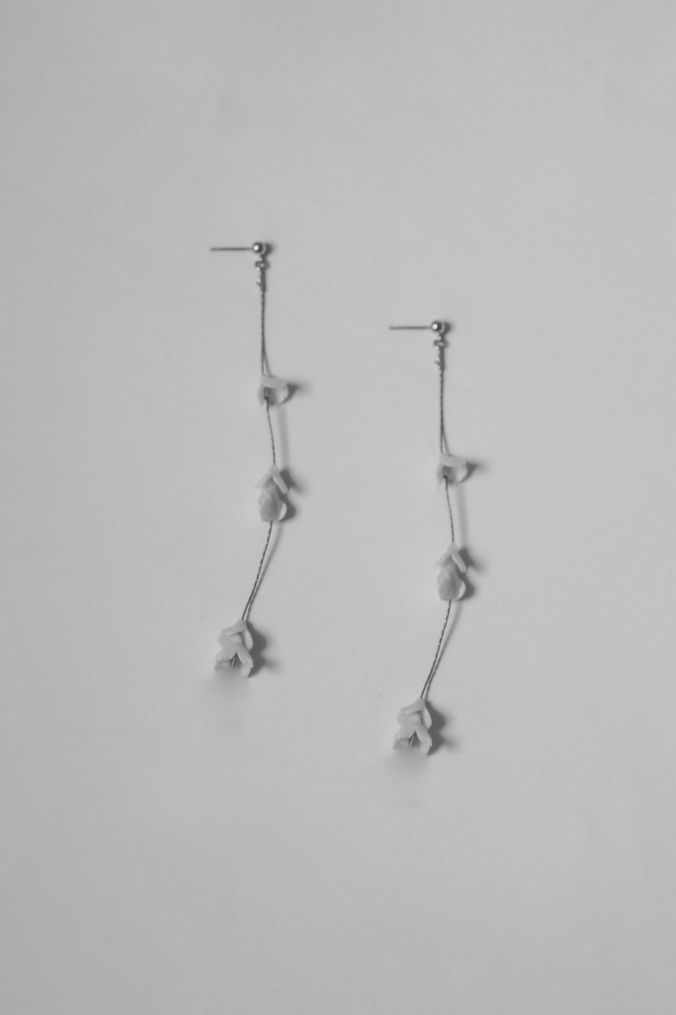 Black and white flat photo of the blossom strand earrings by AB Elllie on white background