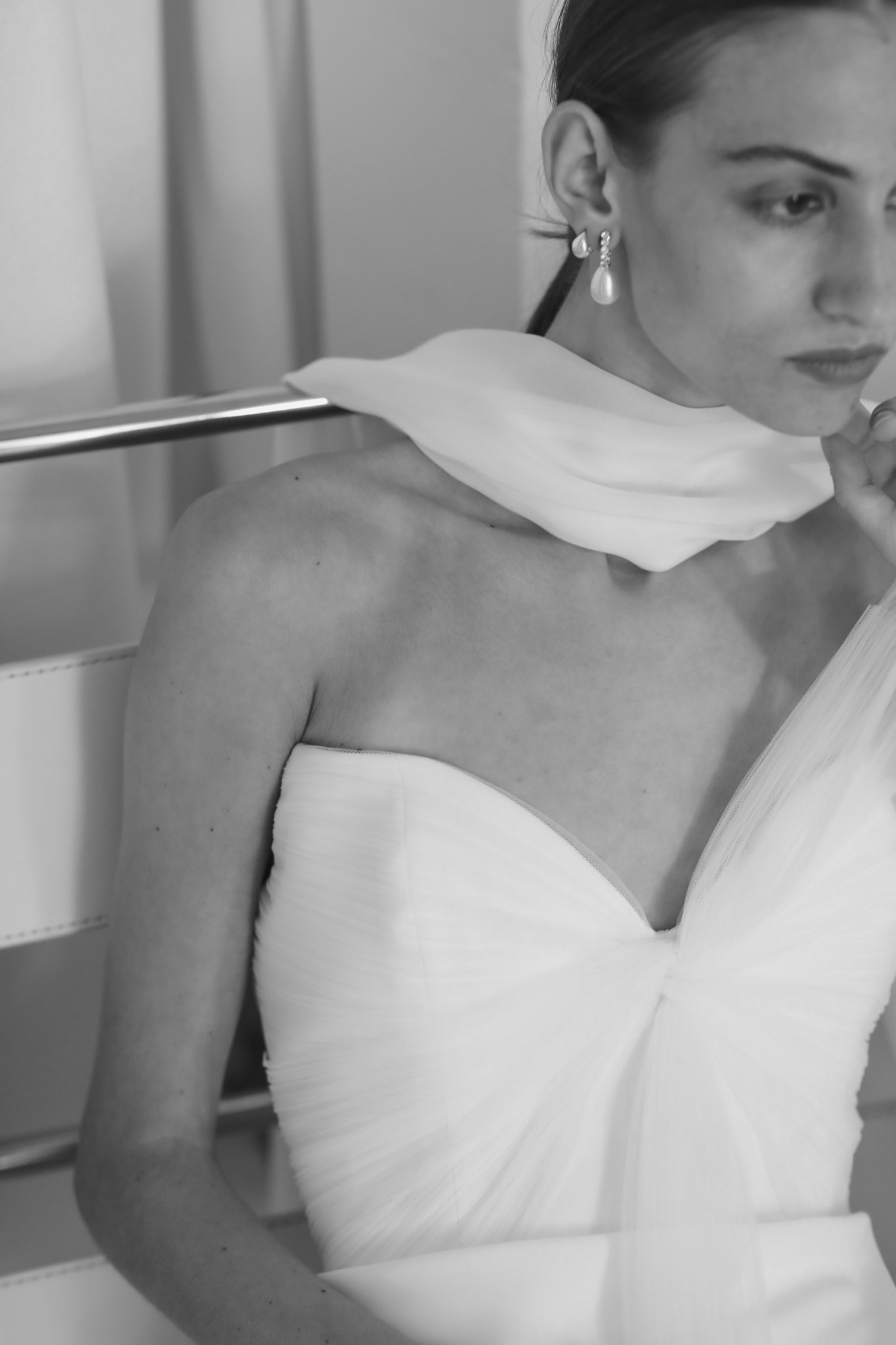 Photo of bride wearing the pave pearl hoop drop earrings by AB Ellie paired with neck scarf