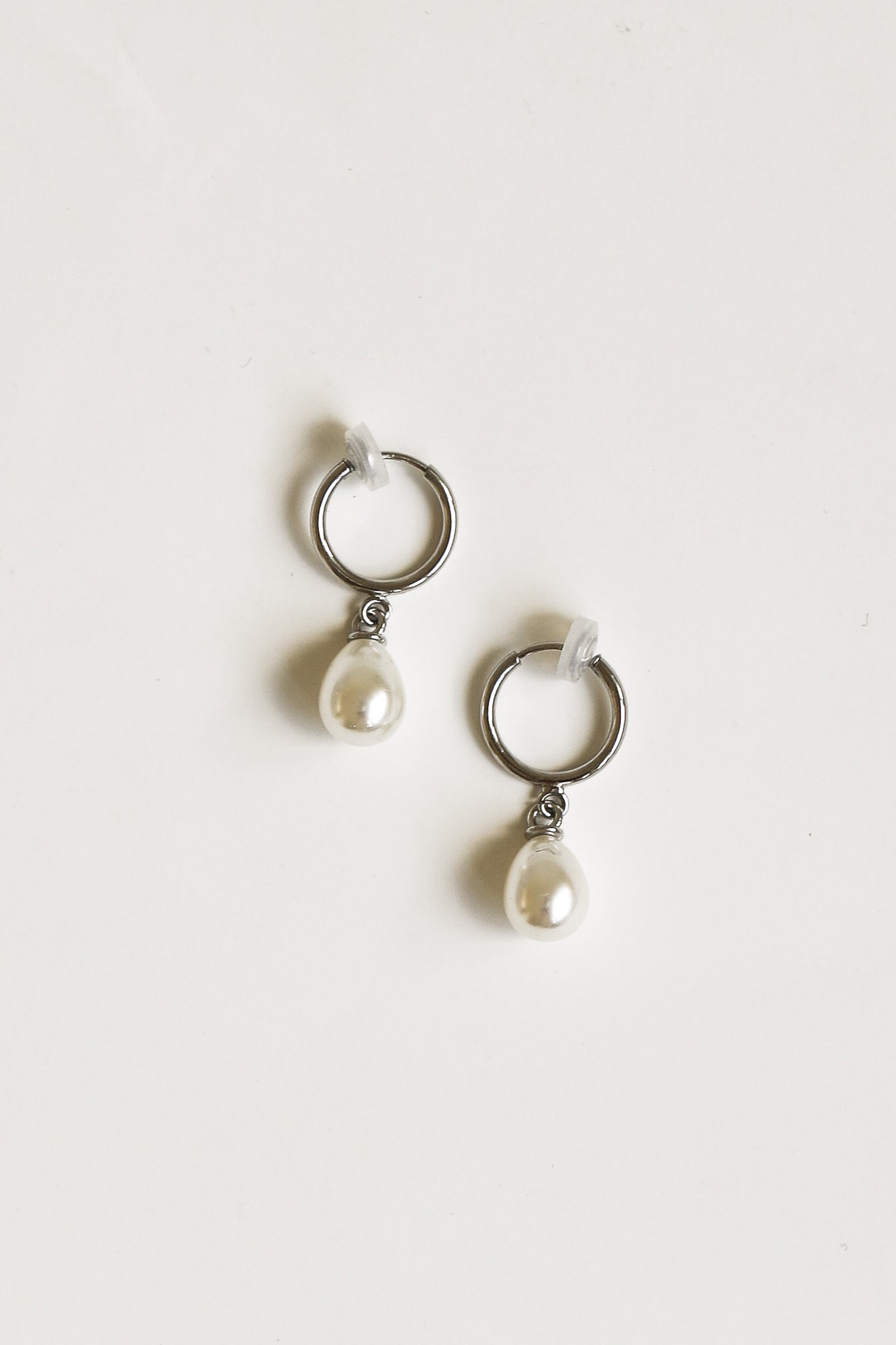 Flat photo of the clip on pearl hoop drop earrings by AB Ellie on white background