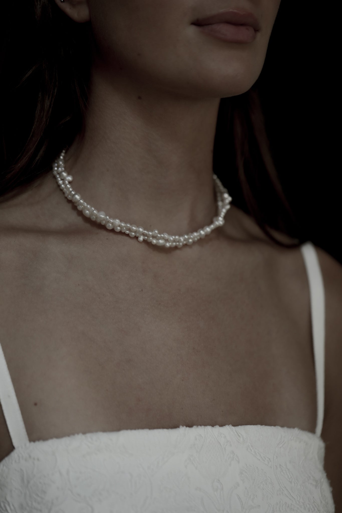 Front view photo of brunette bride wearing the double freshwater pearl strand necklace by AB Ellie paired with lace wedding dress