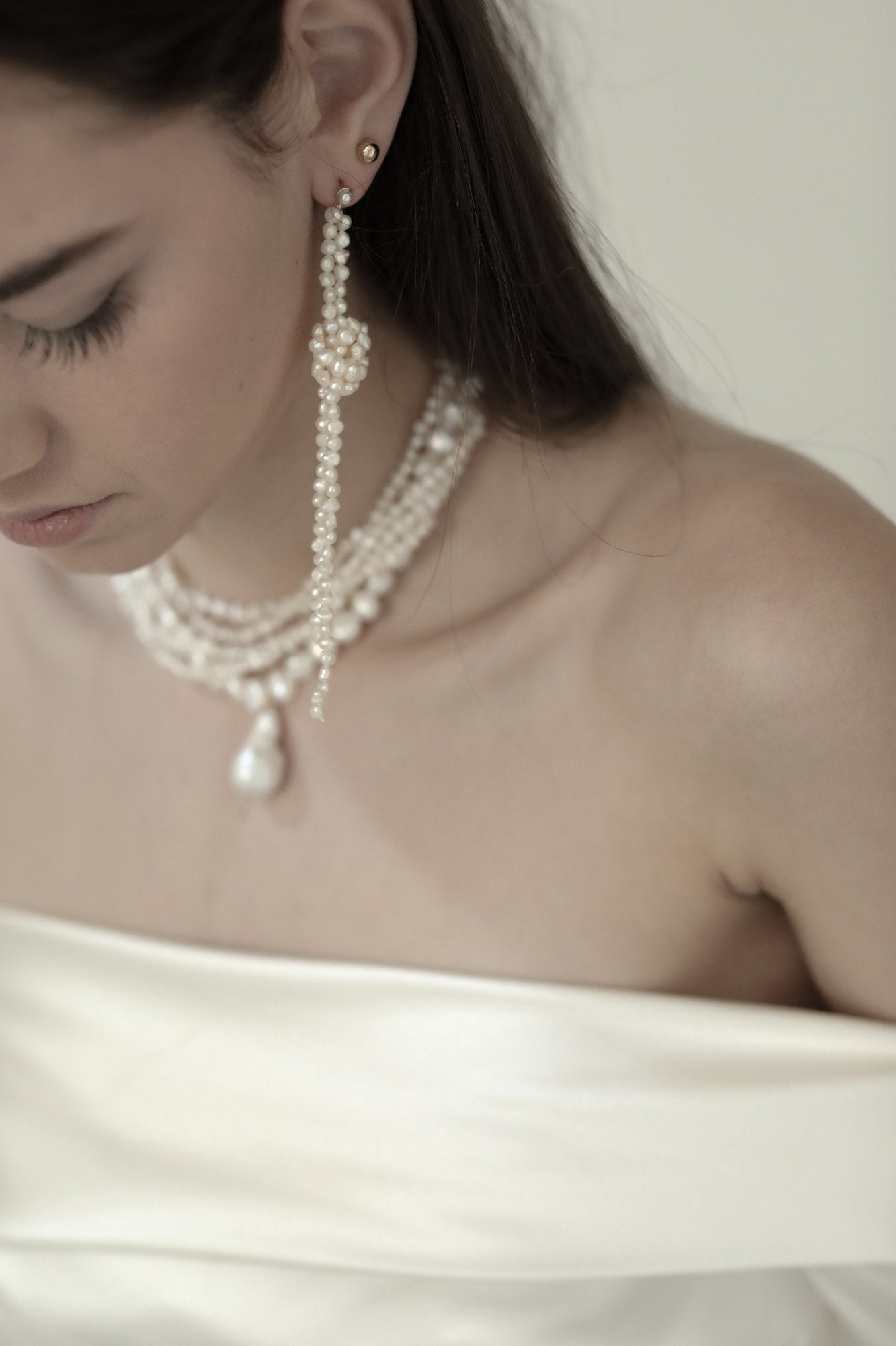 Photo of bride wearing the knotted freshwater pearl earrings by AB Ellie with off shoulder dress