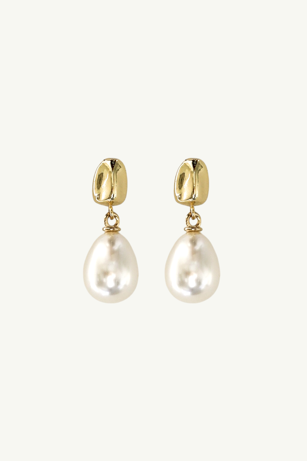 Flat photo of the gold orb pearl drop earrings by AB Ellie on white background