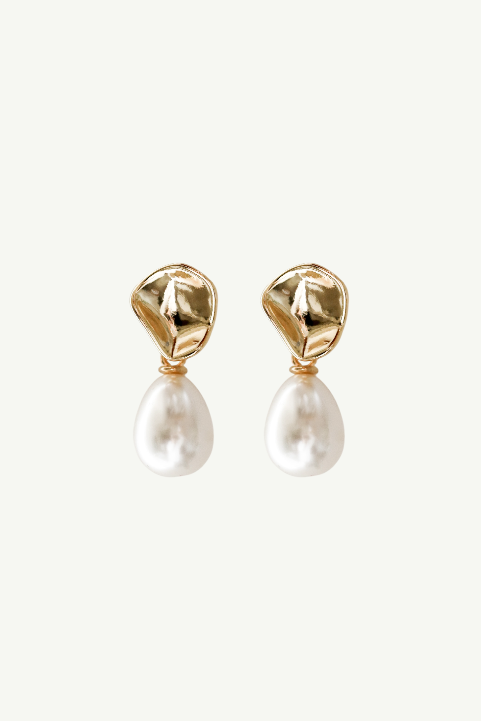 Flat photo of the gold sculptural mini pearl drop earrings by AB Ellie on white background