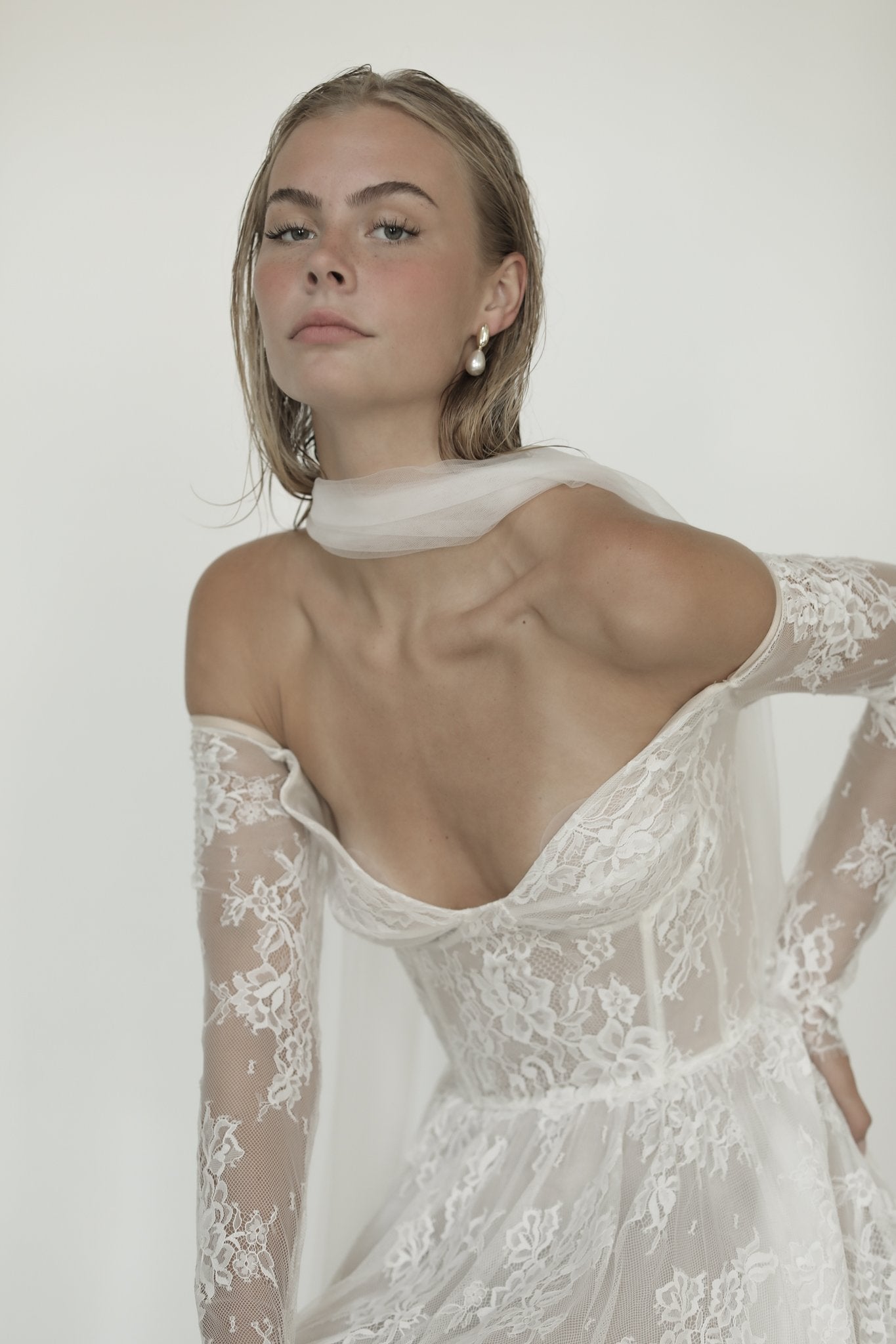 Blonde bride wearing gold pearl drop earrings by AB Ellie with a strapless lace dress