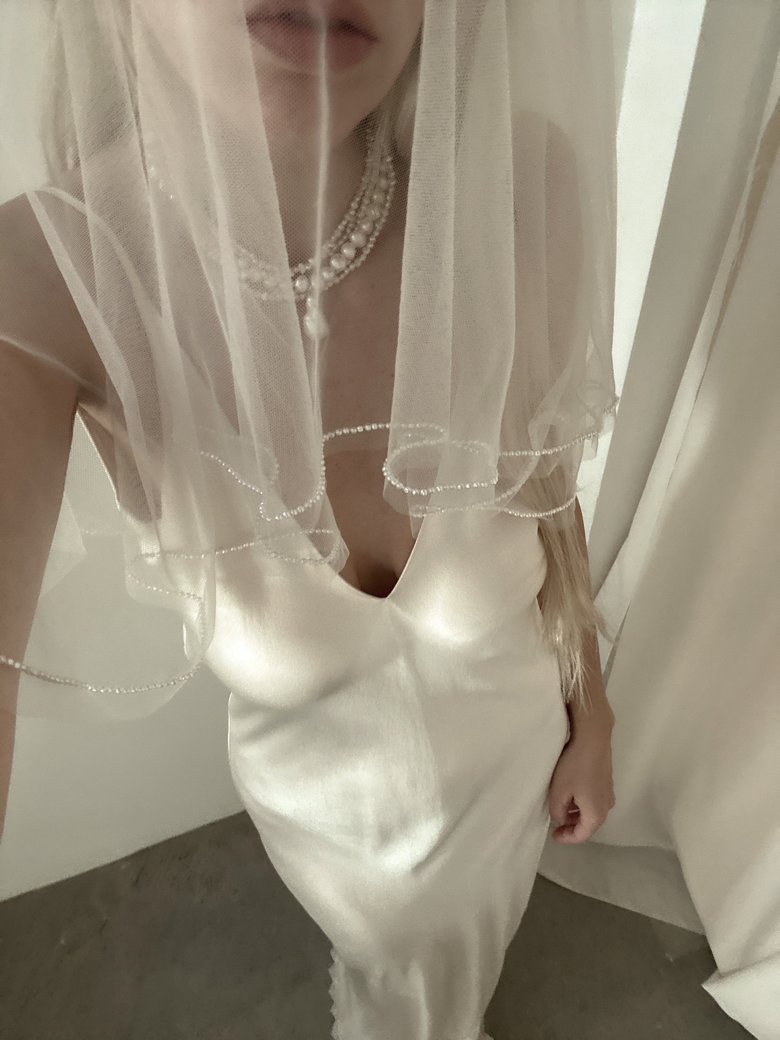 Bride wearing the layered baroque freshwater pearl necklace by AB Ellie with a blusher veil