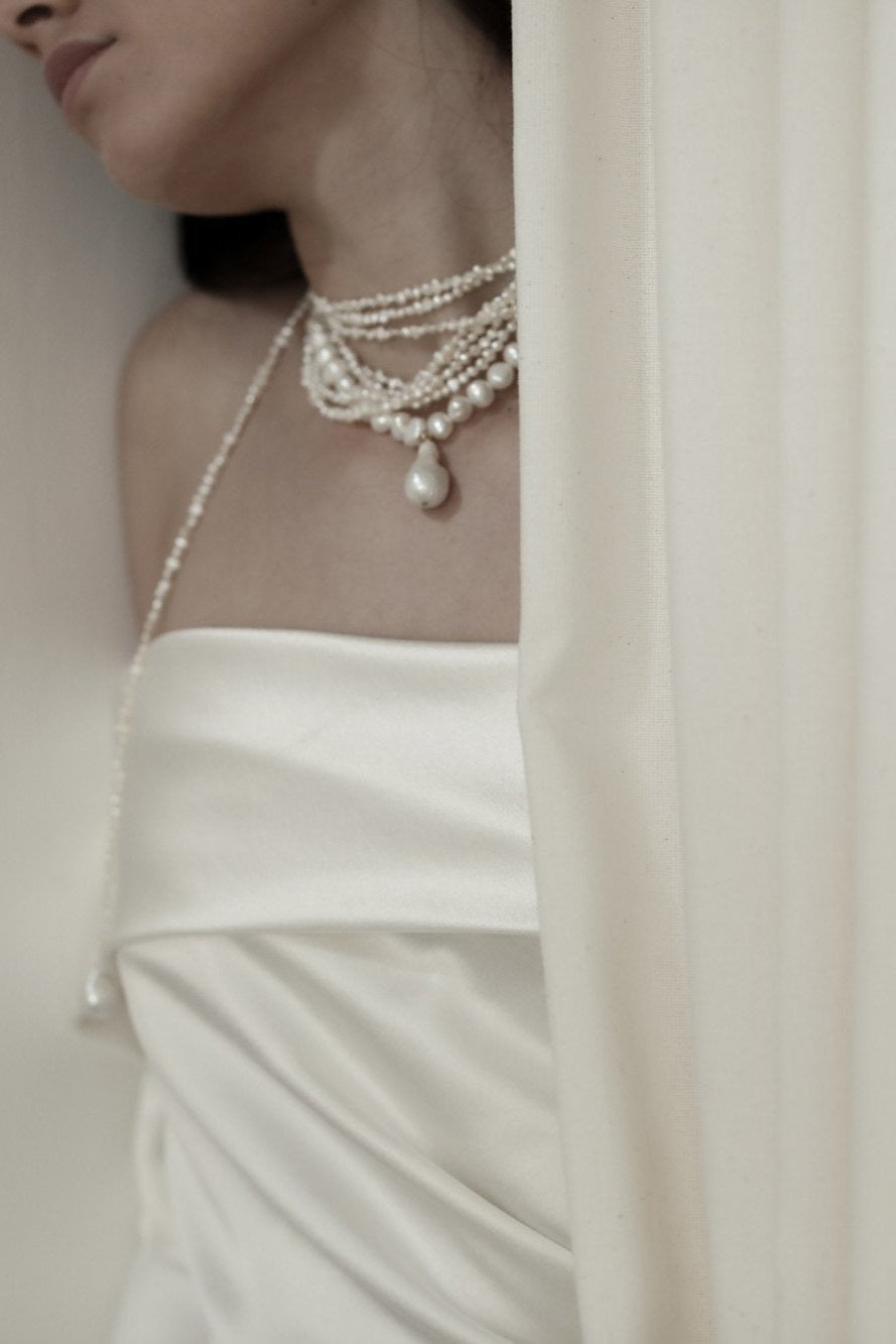 Bride wearing layered baroque freshwater pearl necklace by AB Ellie with strapless wedding dress